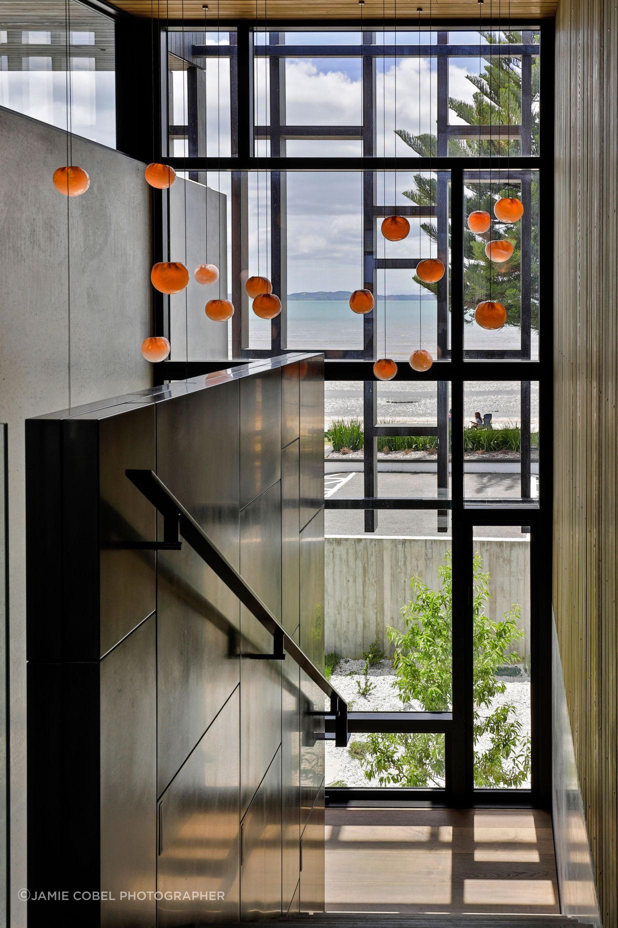 Climbing the stairs, the sea view is taken in through the timber fretwork pattern.