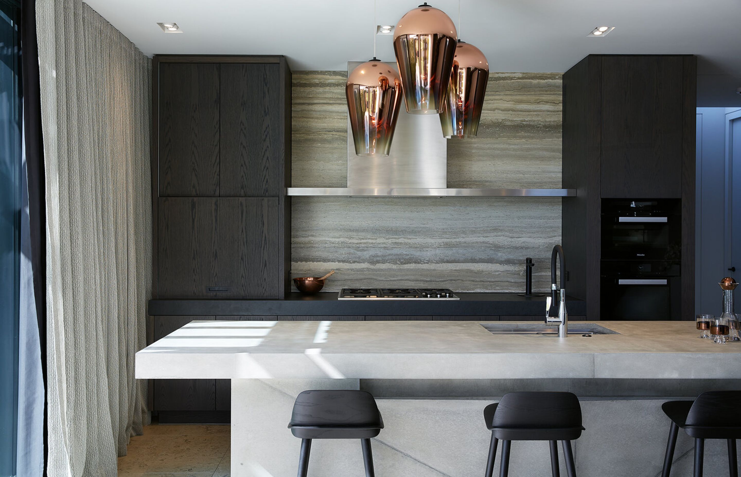 The concrete kitchen island acts as a "rocky outcrop" in the centre of the living/dining space.