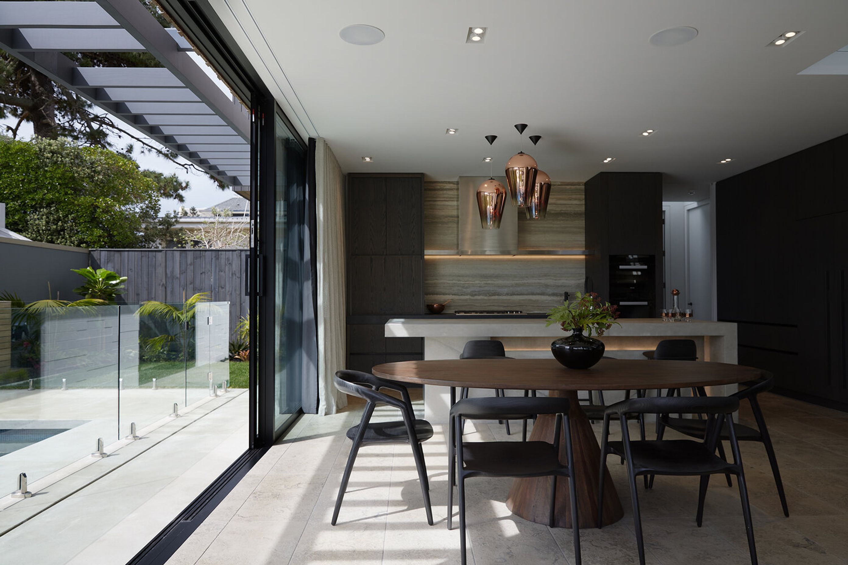 A large, floor-to-ceiling sliding door creates seamless indoor-outdoor flow.