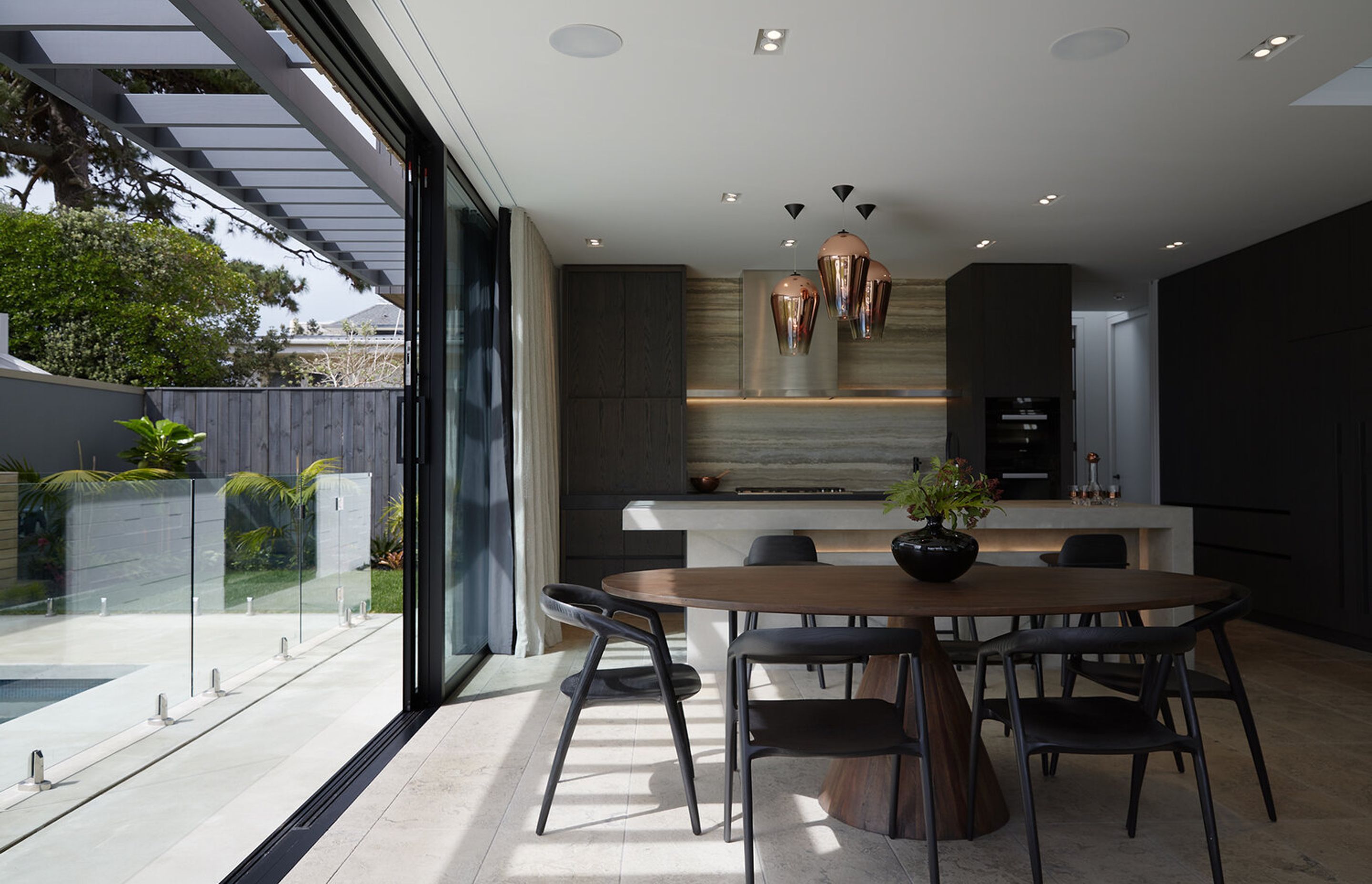 A large, floor-to-ceiling sliding door creates seamless indoor-outdoor flow.