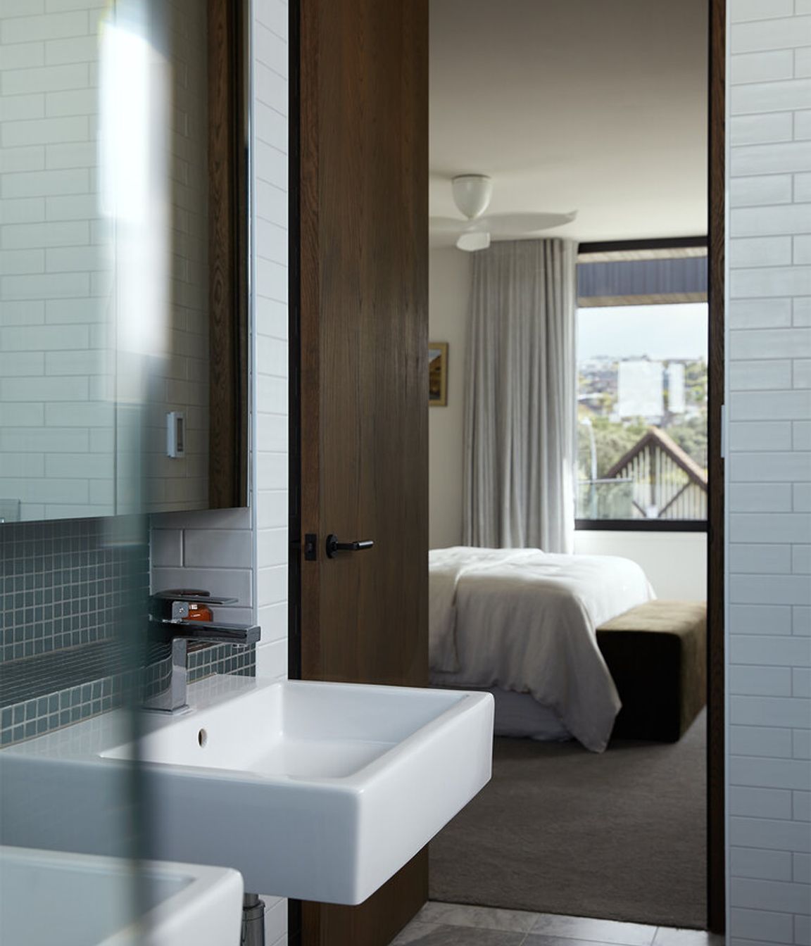The master en suite features classic marble floor tiles and wall tiles in ocean-hues.