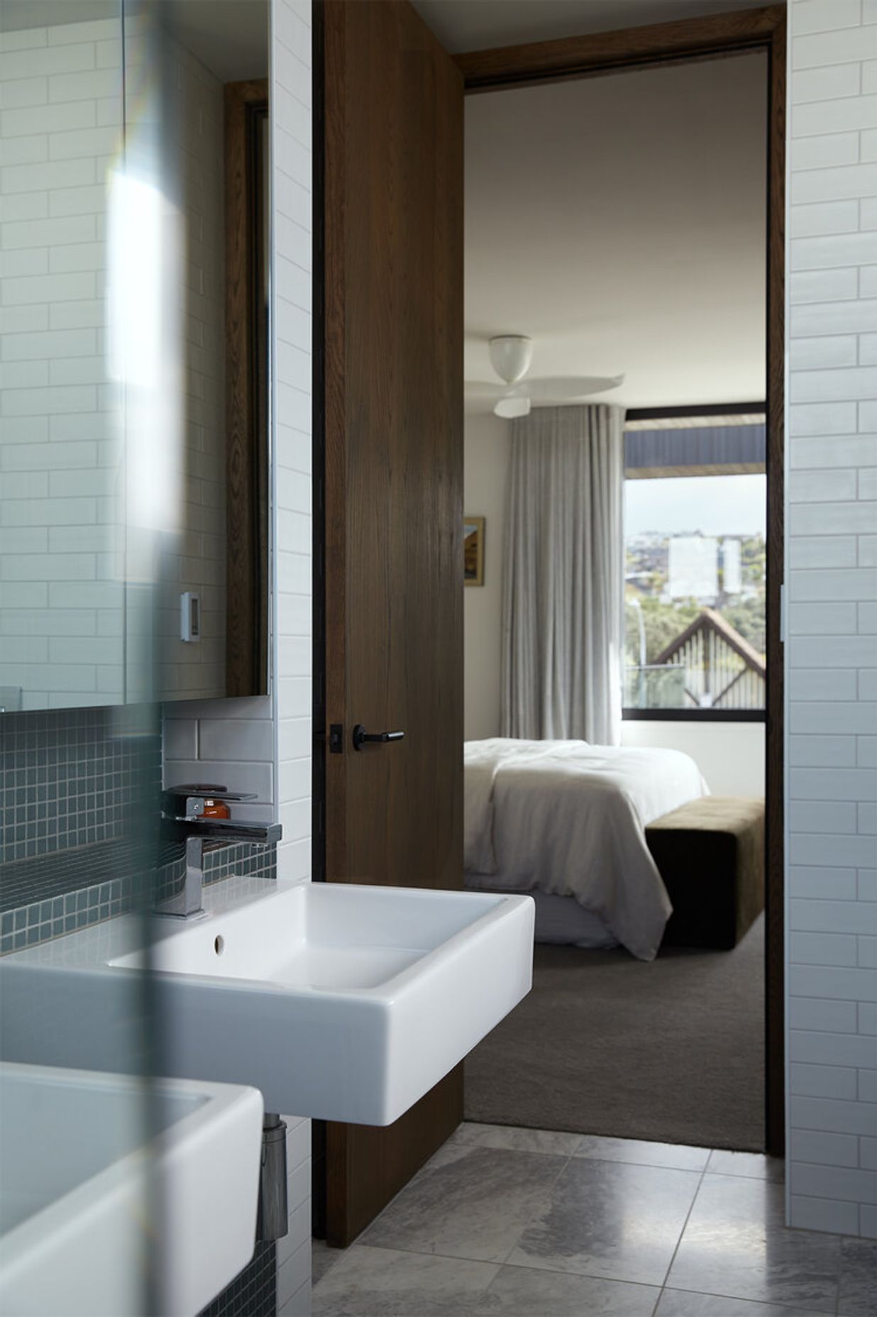 The master en suite features classic marble floor tiles and wall tiles in ocean-hues.