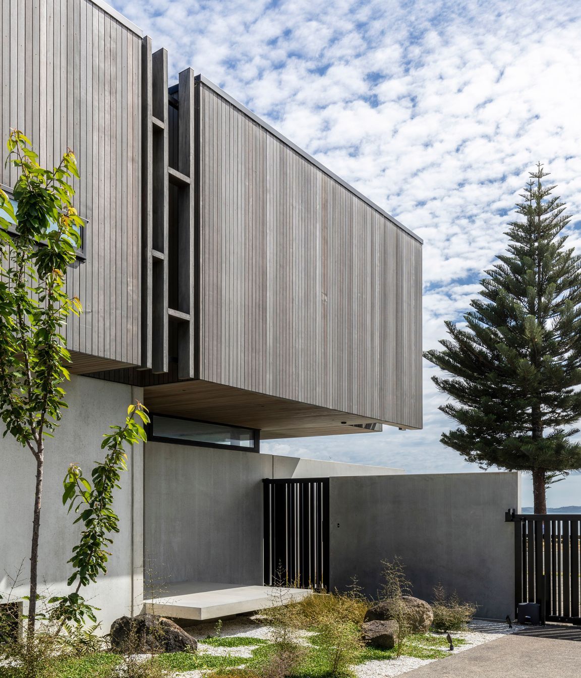 The entry gate opens to a private landing space, before entering the house through the front door.