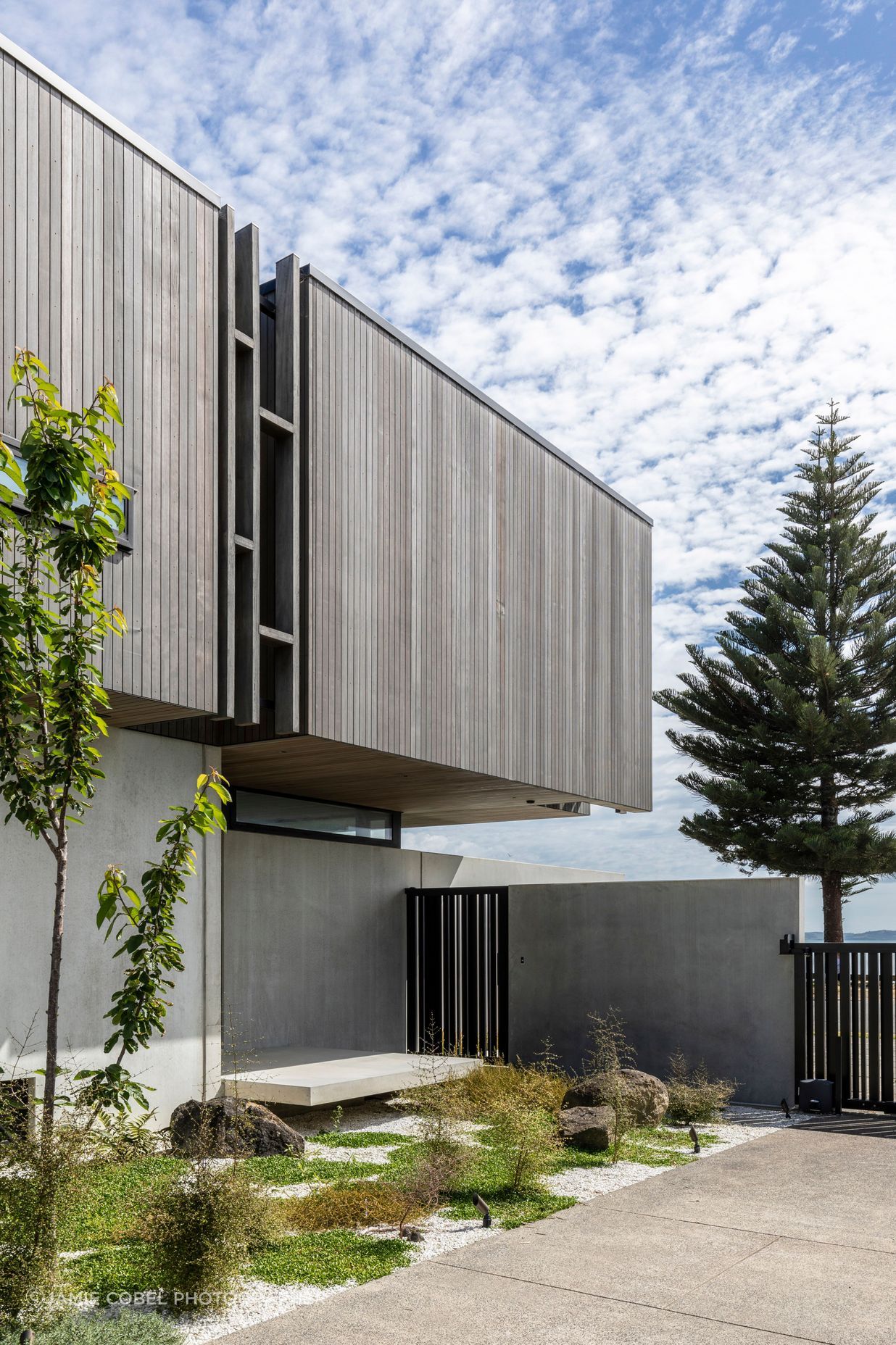 The entry gate opens to a private landing space, before entering the house through the front door.