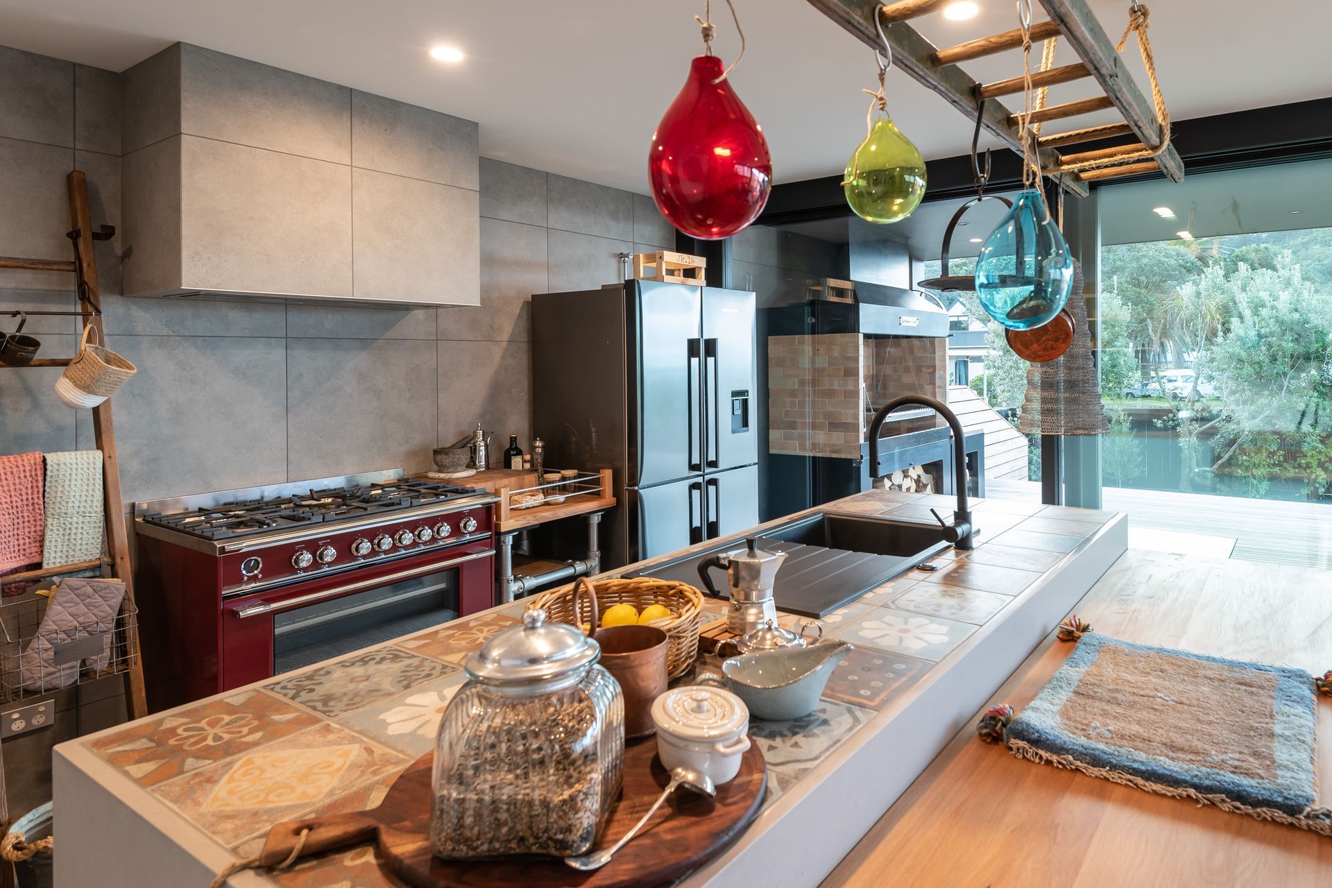 Tracks Ash 600x600mm. Used to great effect across the flooring and up the walls, proving really effective at disguising the range hood.