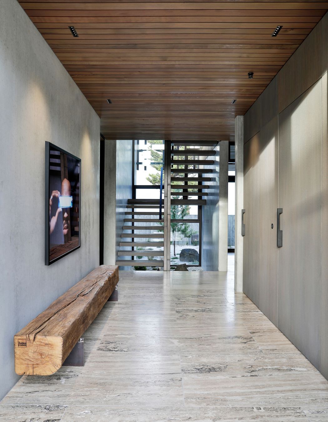 The stair well faces a second hallway that leads to the service and utility spaces.