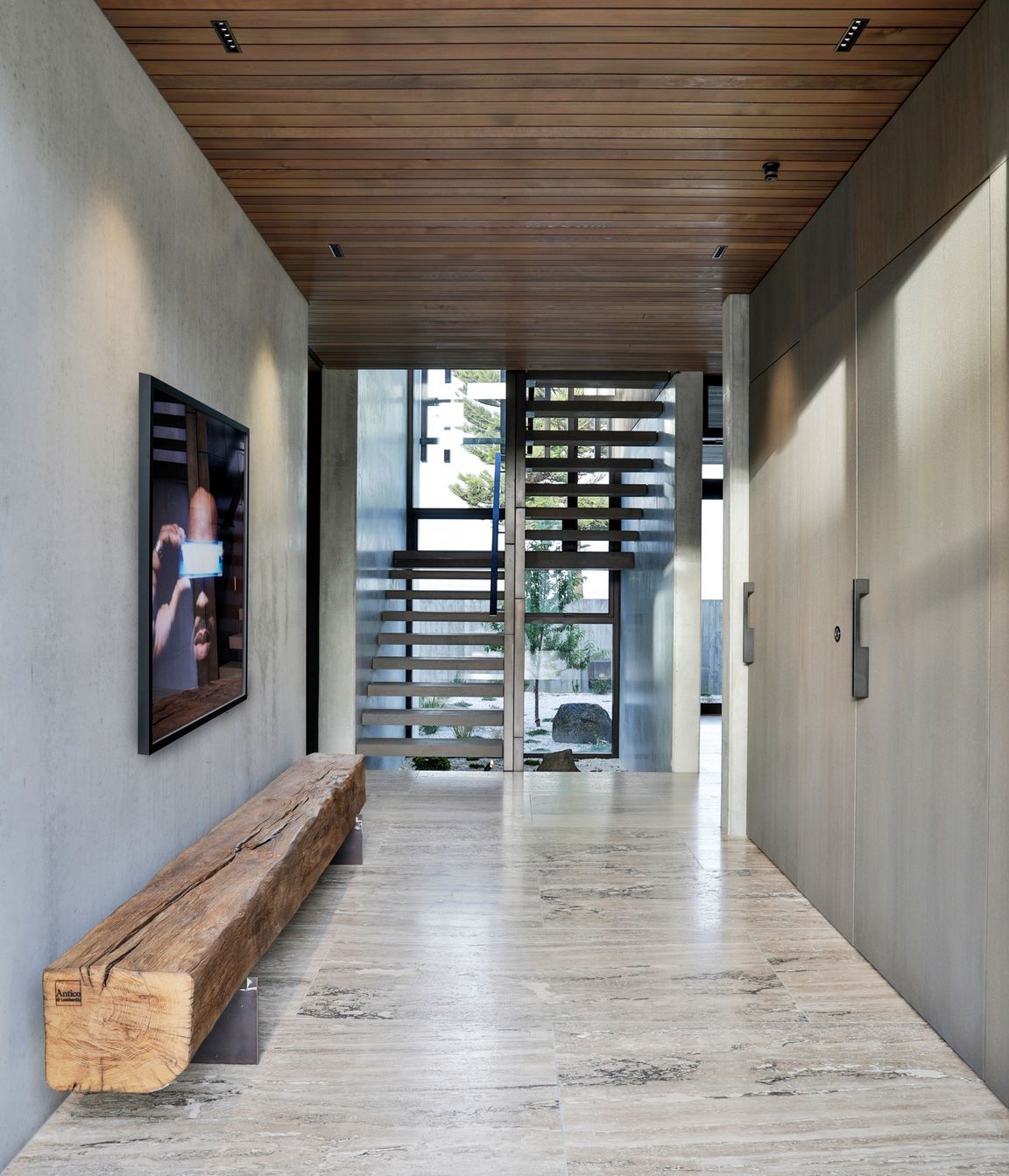 The stair well faces a second hallway that leads to the service and utility spaces.