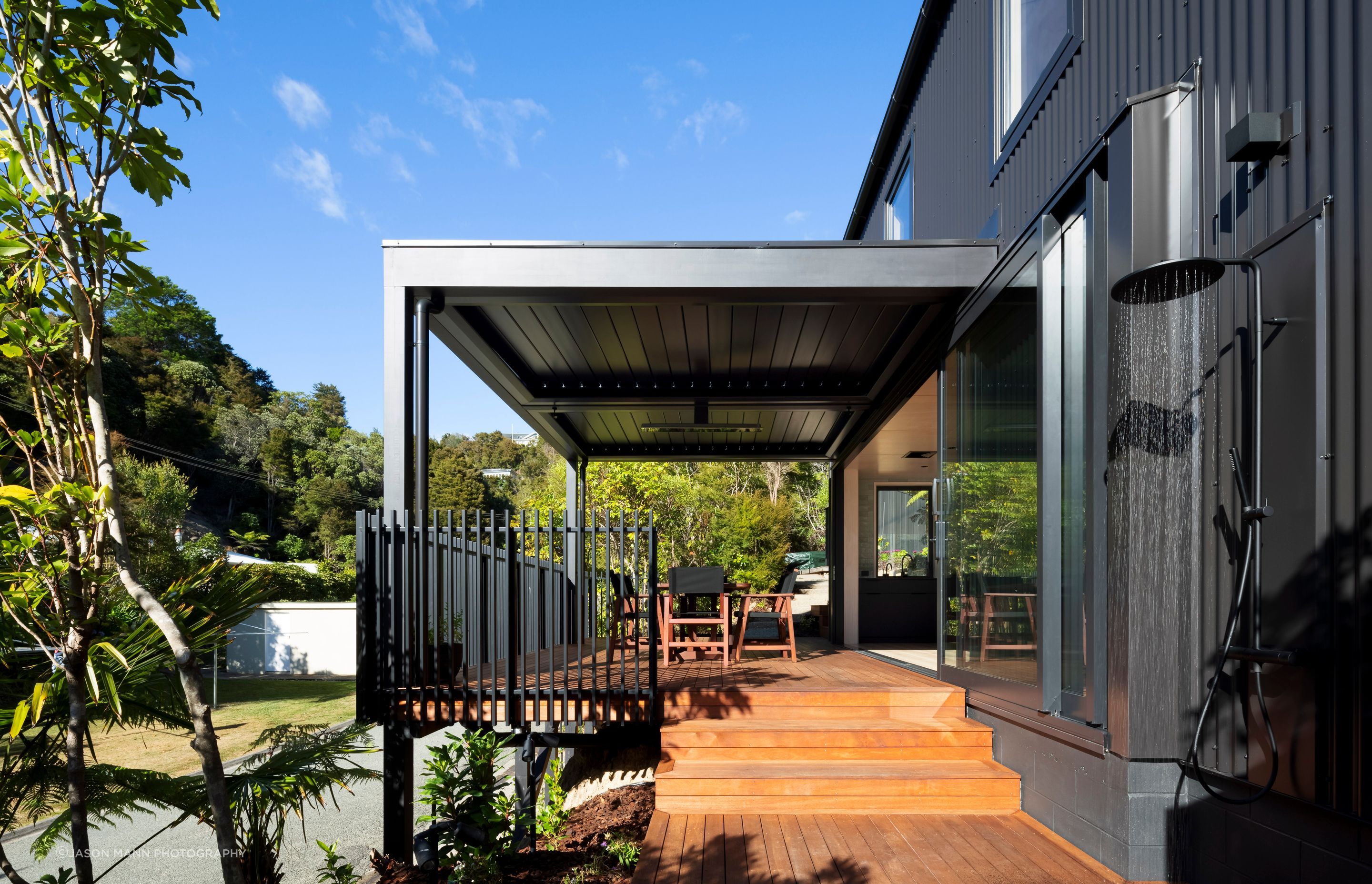 Operable louvres over the central deck increase the area of covered living space outside the small building footprint.”