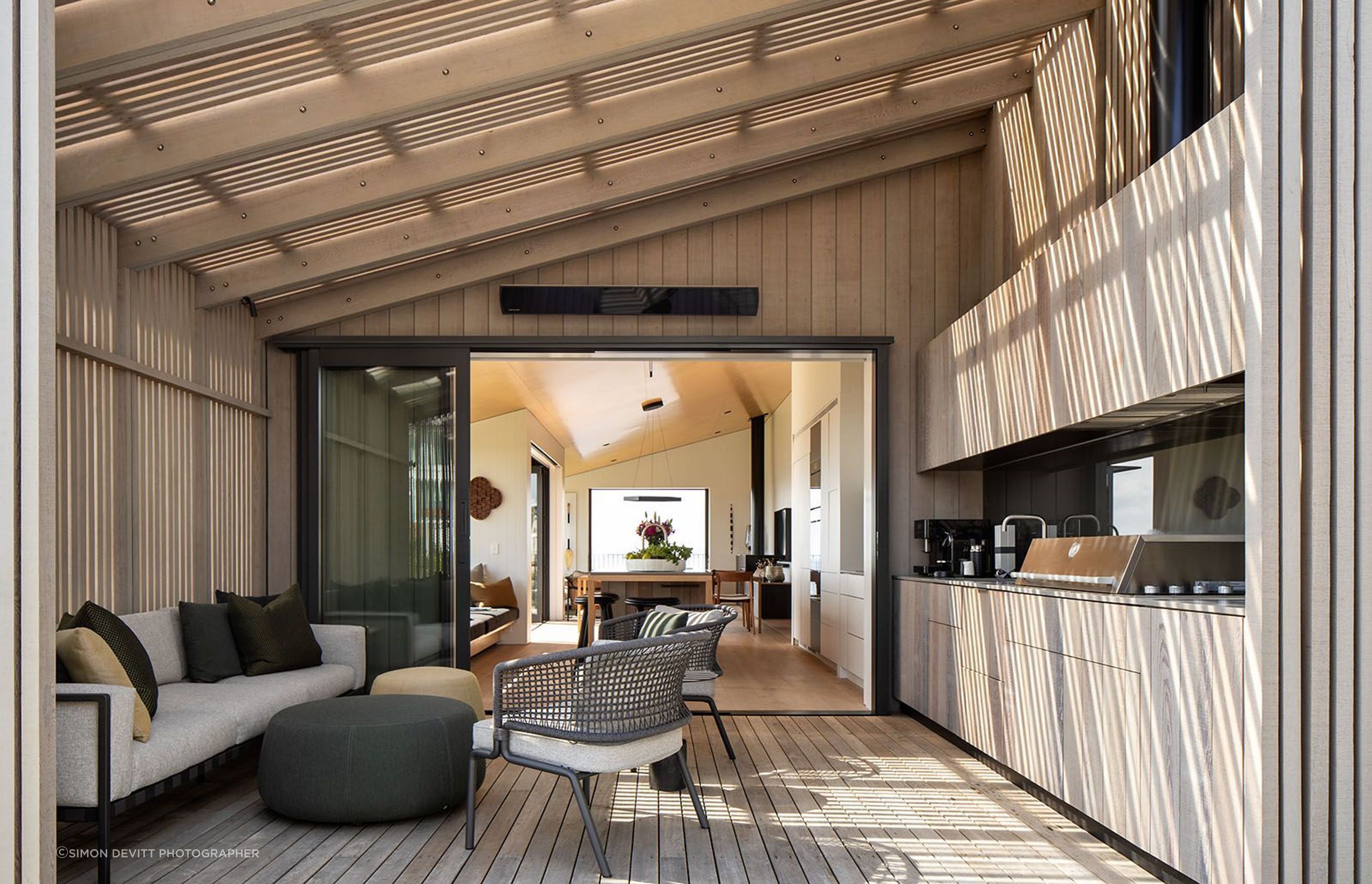 The kitchen projects through the building envelope and out onto layered and screened outdoor living spaces—helping blur the lines between indoor spaces and outdoor spaces.