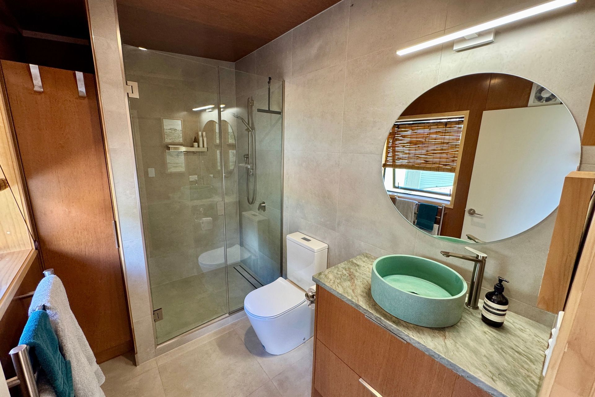 Beautiful tile bathroom with bespoke Meranti plywood vanity and storage