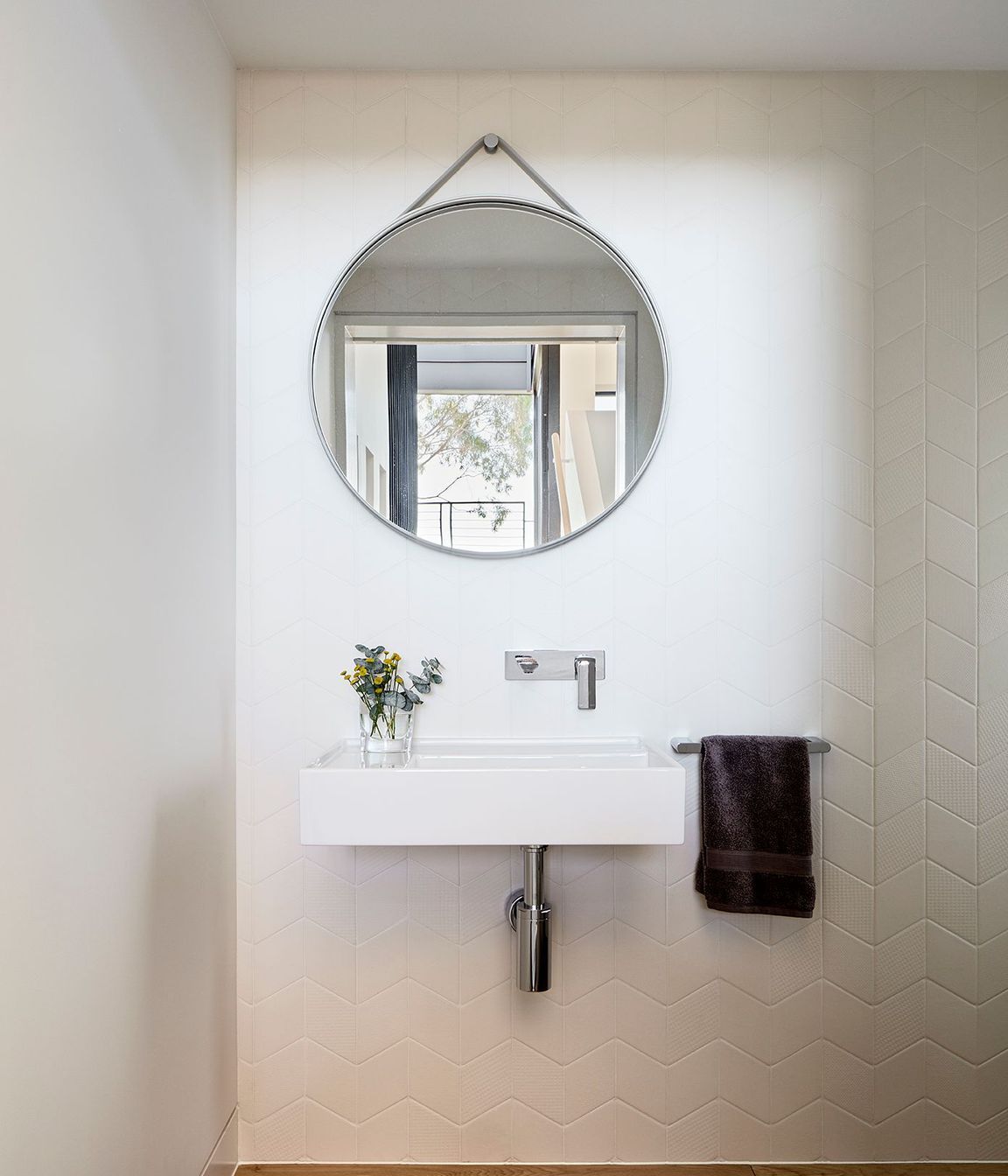 At the mid-point landing of the stairs is a small powder room.