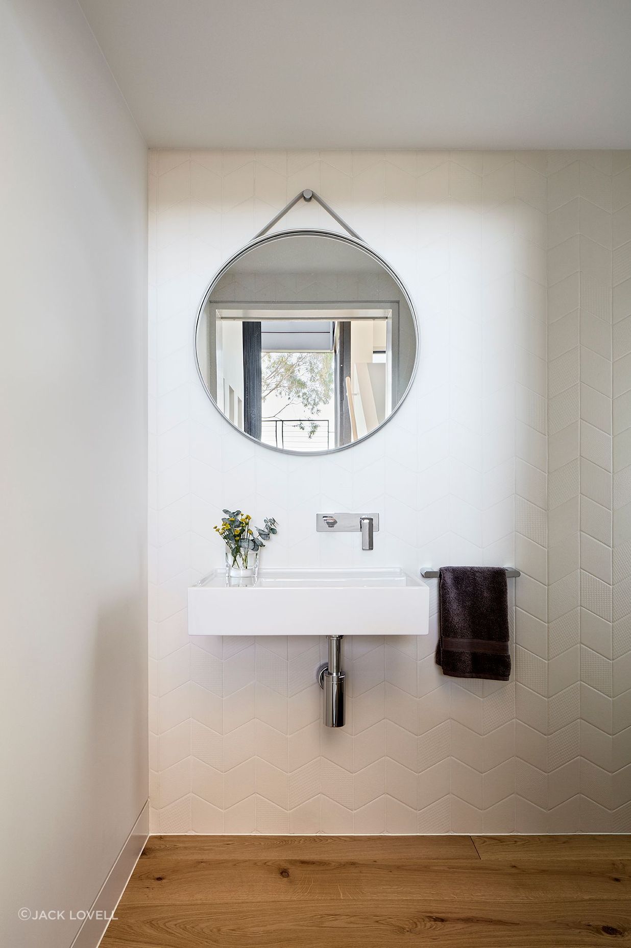 At the mid-point landing of the stairs is a small powder room.