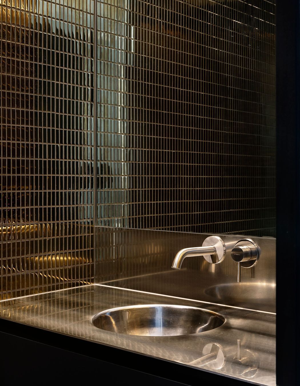 The tiles in the downstairs WC are dark and moody.