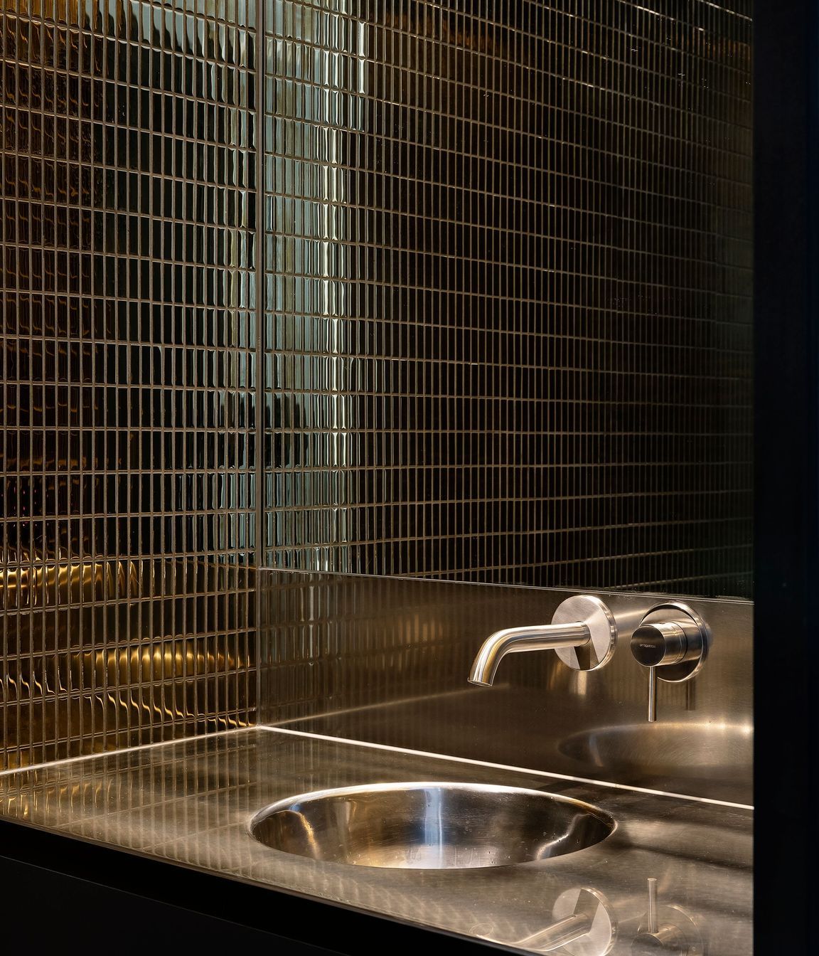 The tiles in the downstairs WC are dark and moody.