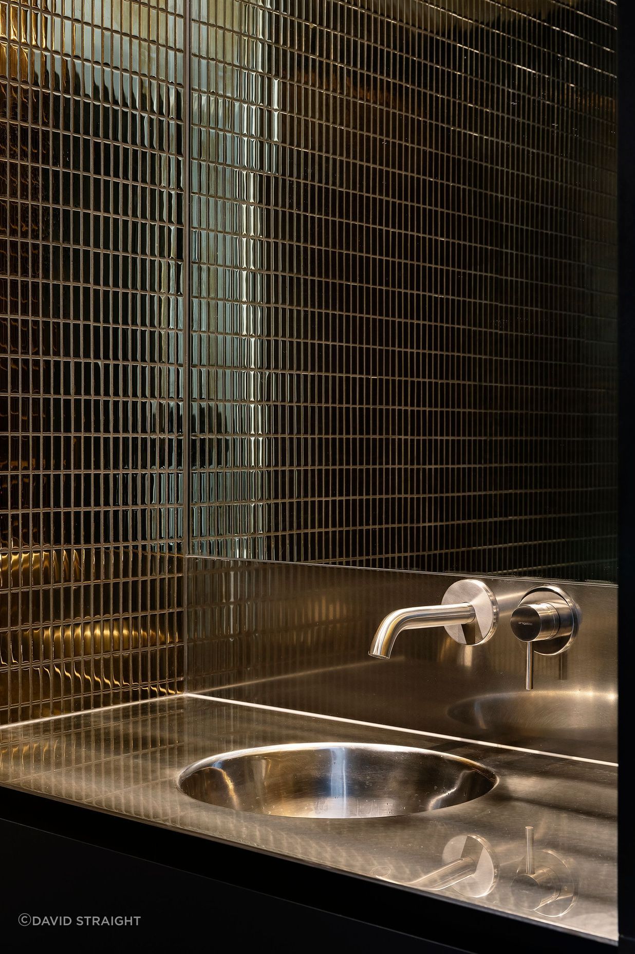 The tiles in the downstairs WC are dark and moody.