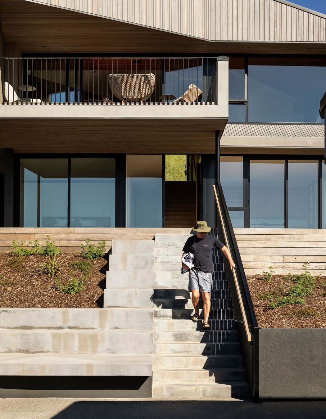 Concrete plinths alongside the stair provide a spot to congregate or leave kayaks and surf boards.