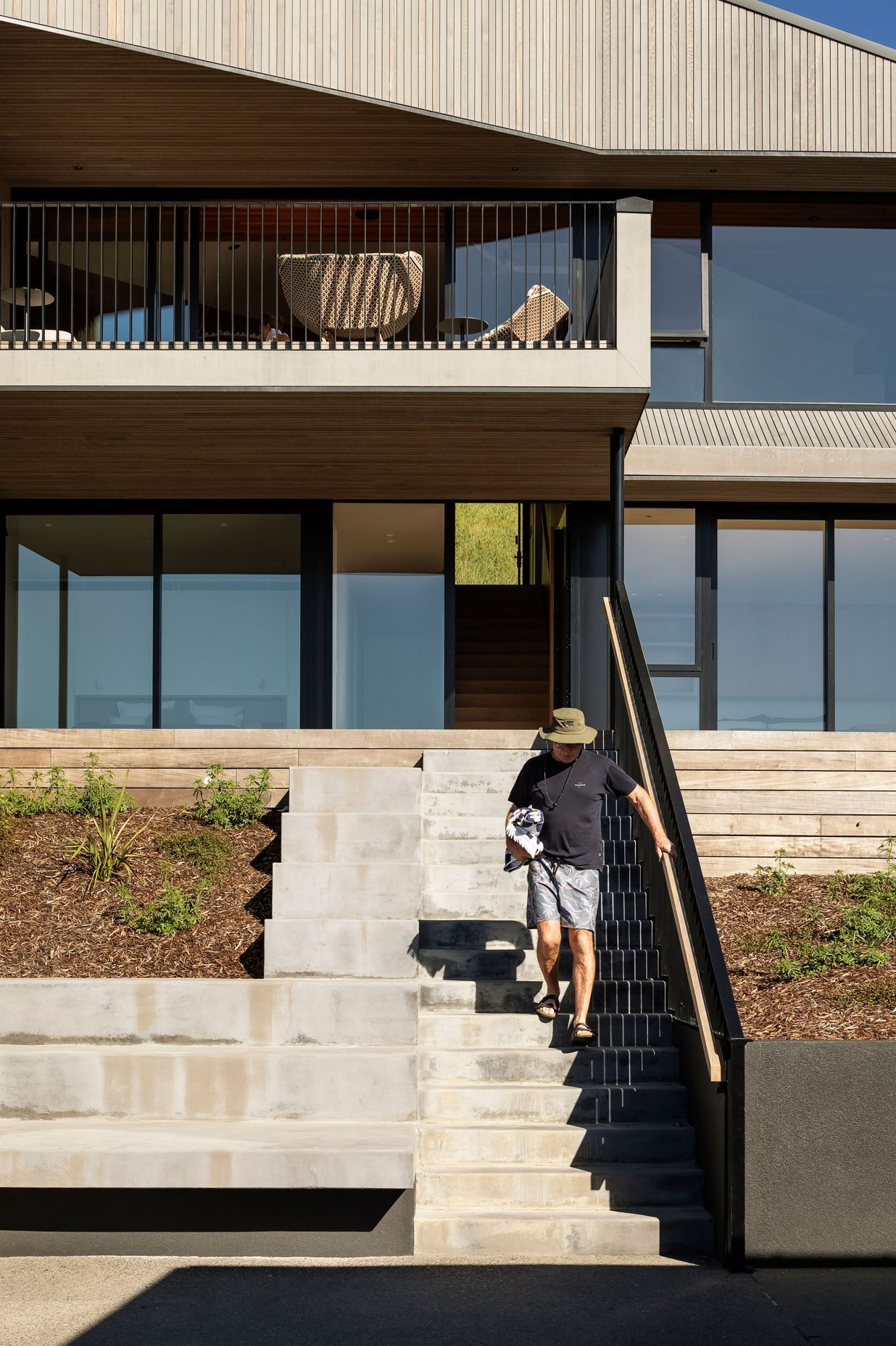 Concrete plinths alongside the stair provide a spot to congregate or leave kayaks and surf boards.