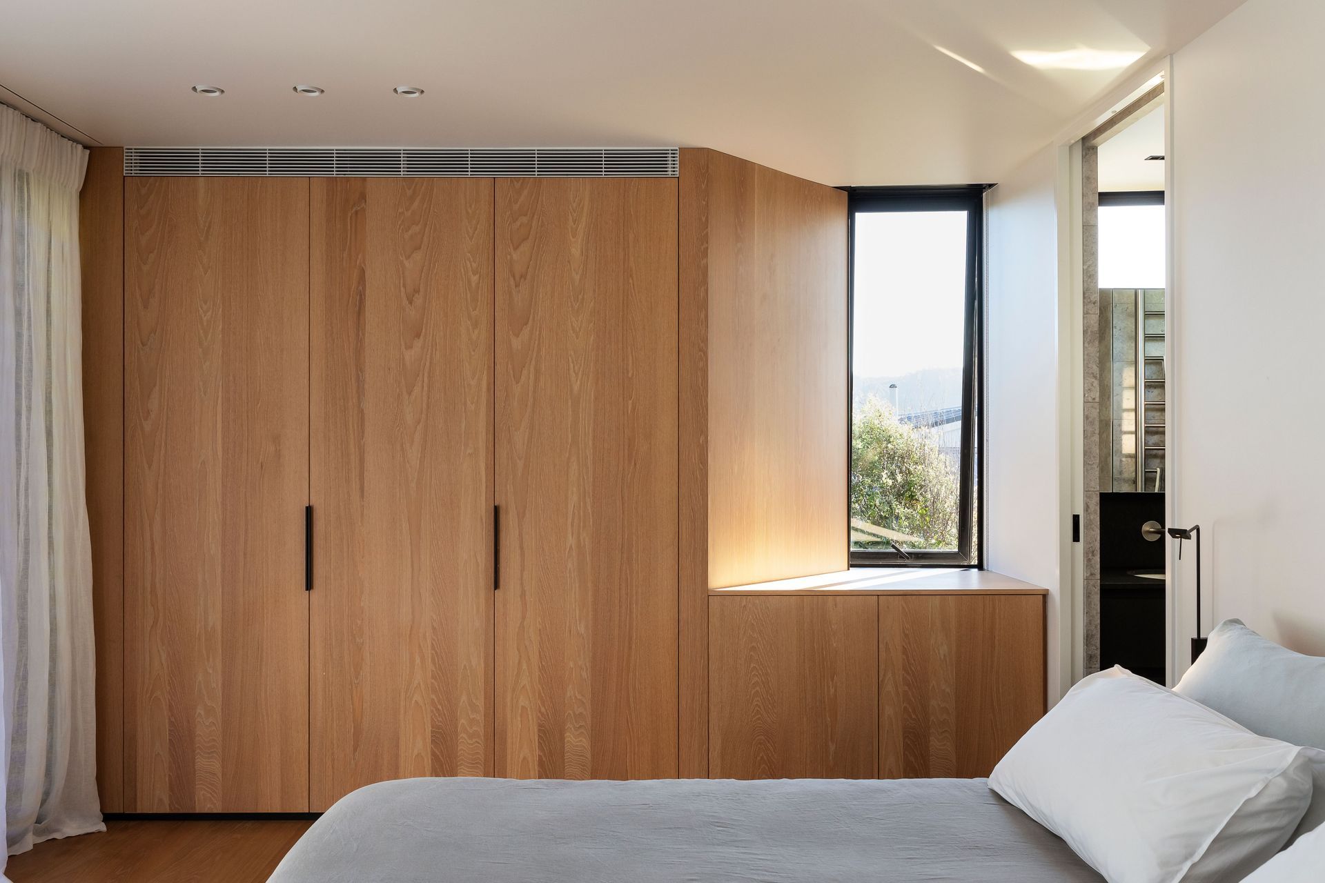 The master suit enjoys morning sun and views back up to the hillside behind the house.