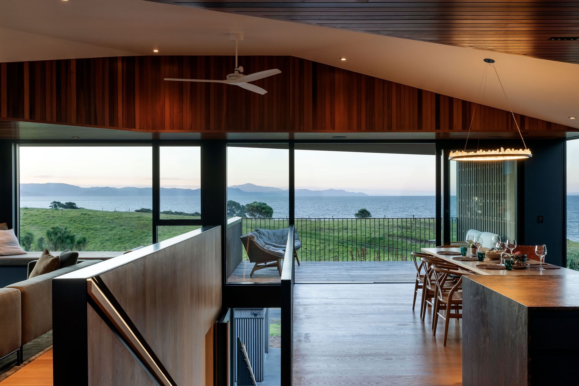 The kitchen/dining and lounge are separated by the central staircase.