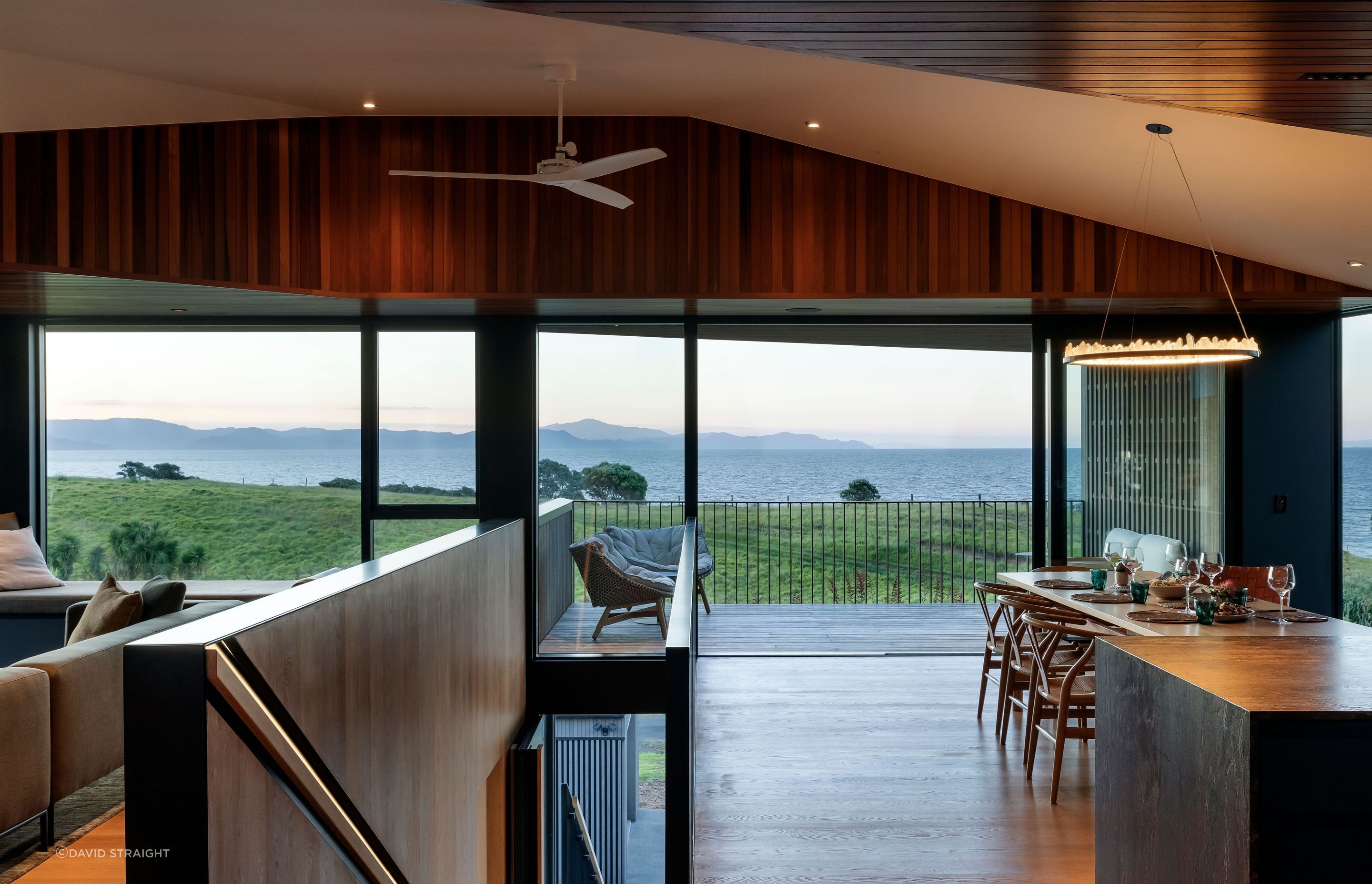 The kitchen/dining and lounge are separated by the central staircase.