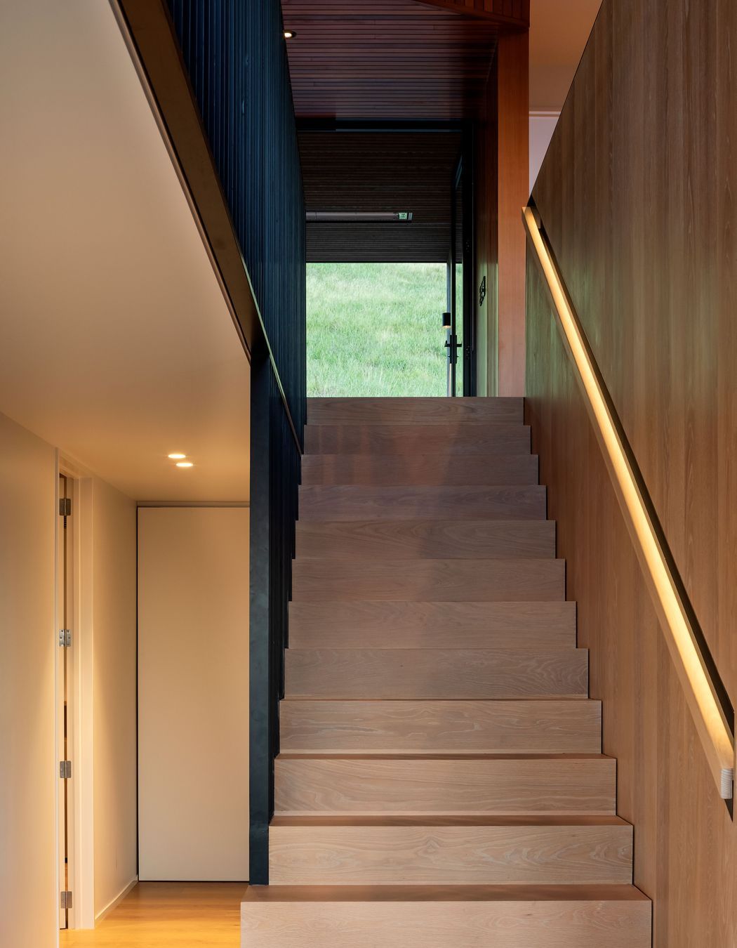 The central staircase leads up to the living spaces.