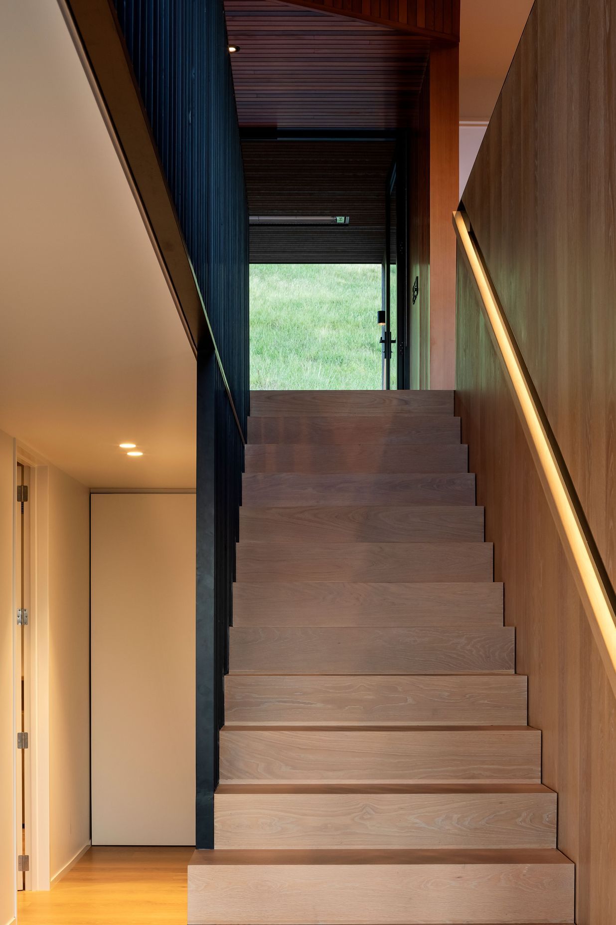 The central staircase leads up to the living spaces.