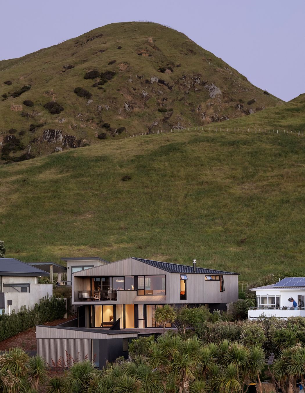 The hill appears to preside of the home.