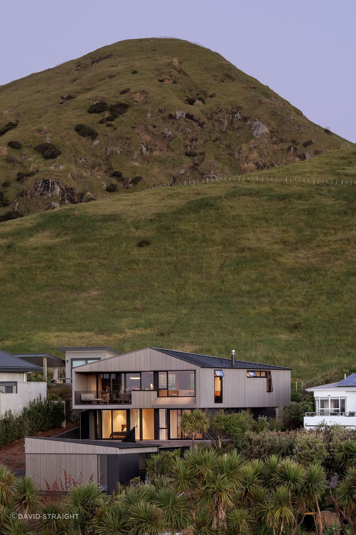 The hill appears to preside of the home.
