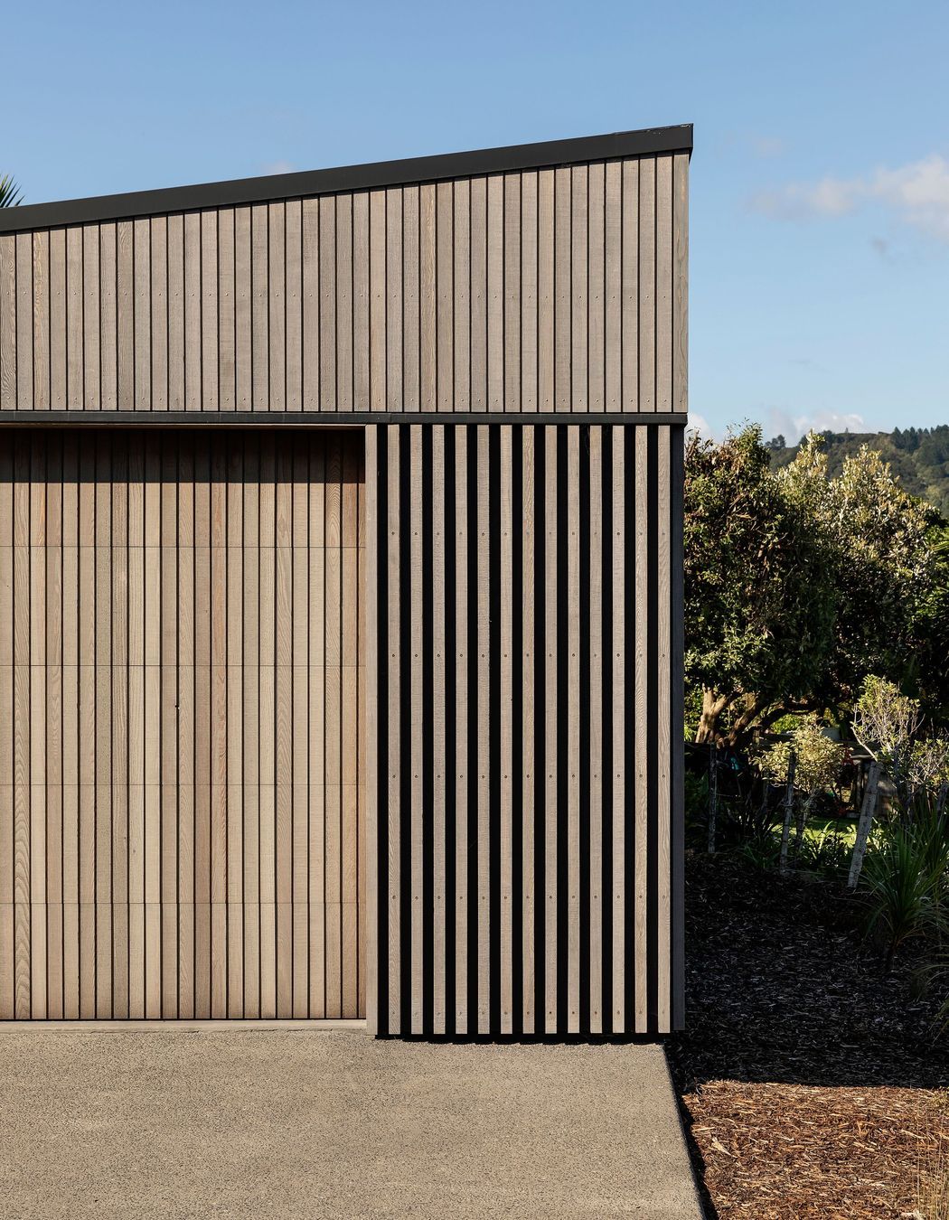 The garage was conceived a separate form and sits below the house on the site.