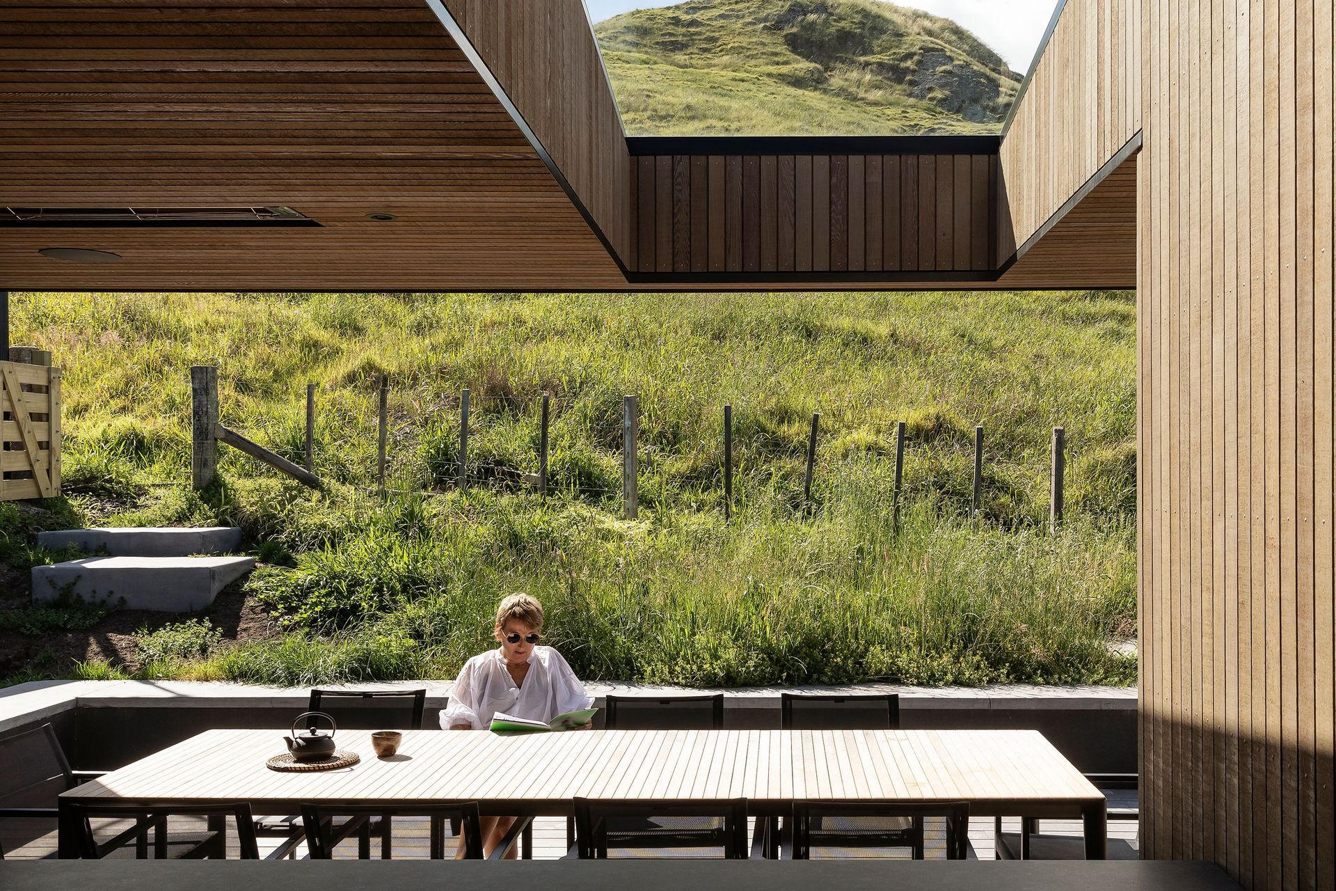 A slot cut into the roof overhang in the outdoor entertainment space provides a perfect picture window of the hilltop, and lets light into the house.