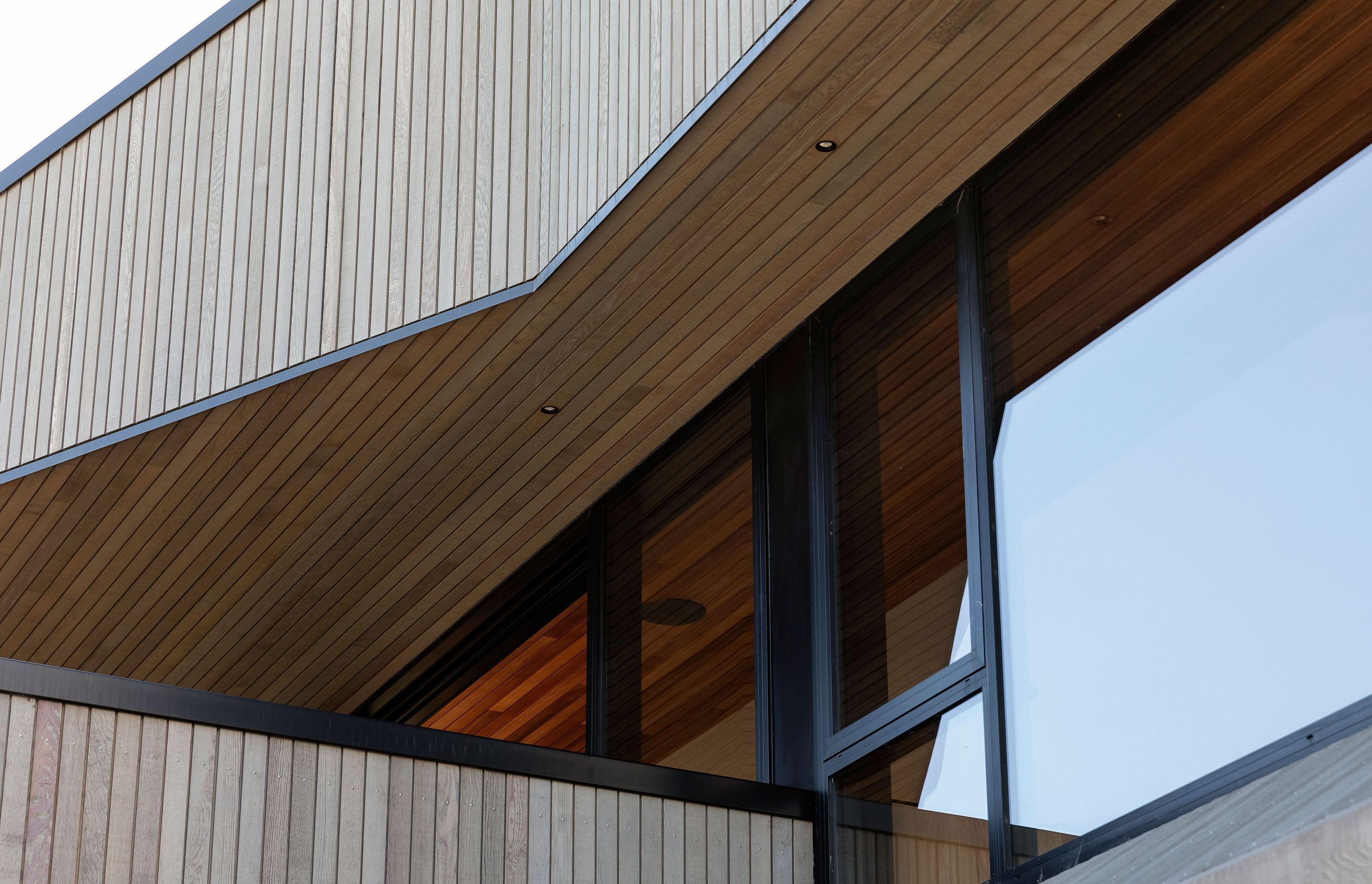 The angular cedar elevations give the home a sculptural quality.