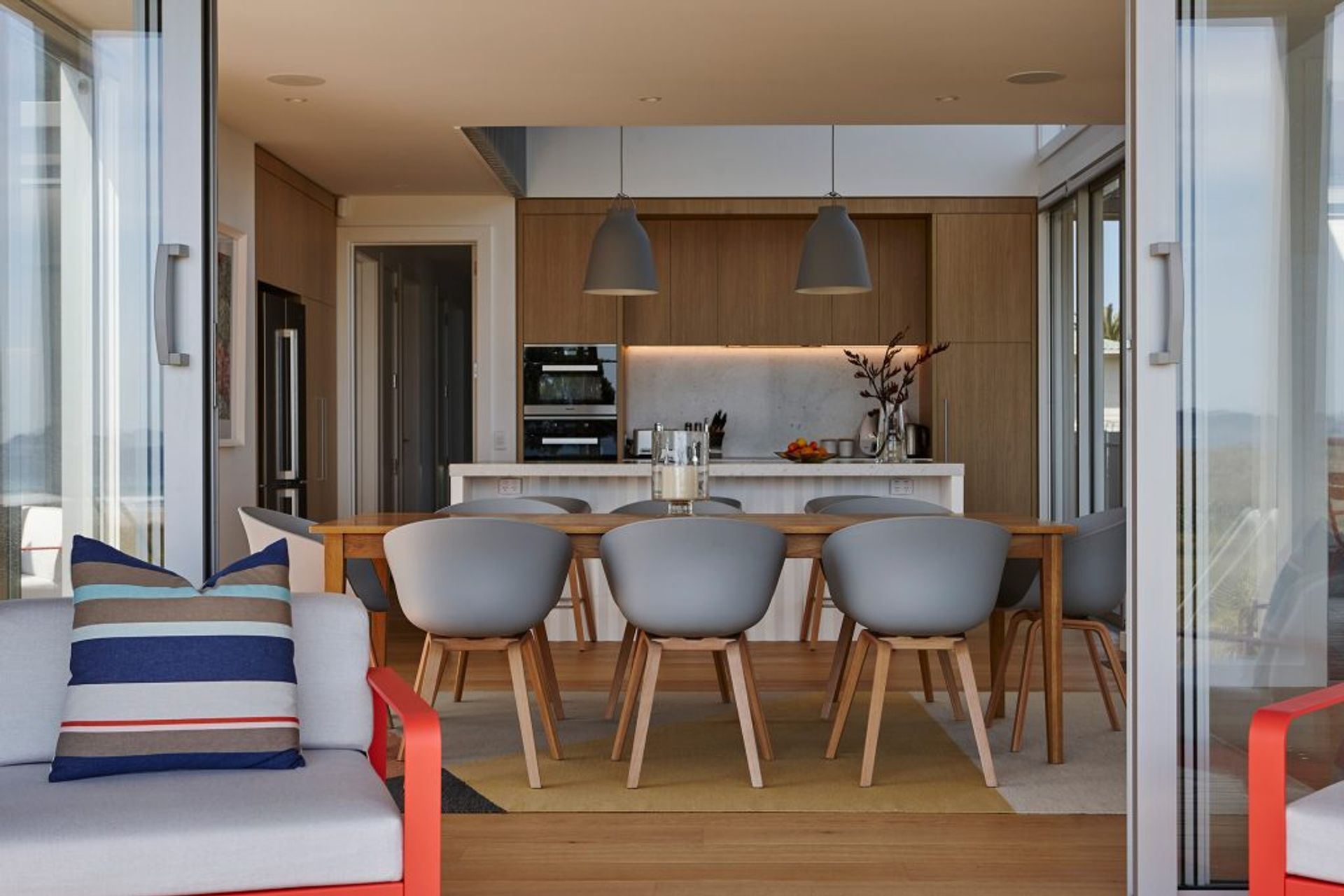 In the kitchen, Caravaggio pendants and Hay dining chairs and bar stools are from Cult.