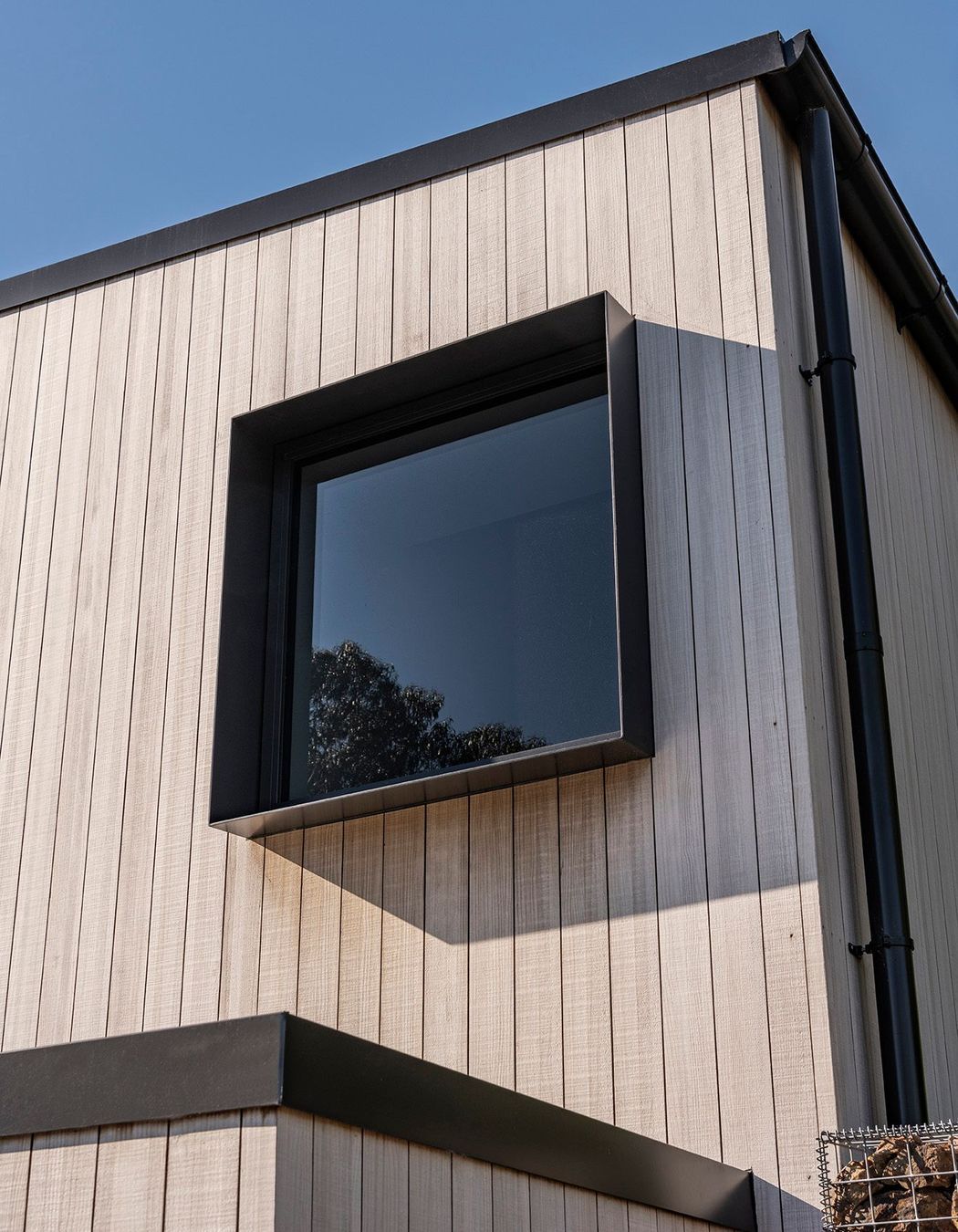 Extrusions play an equal part to break up the silver tones and simple forms of the upper story 'Box'