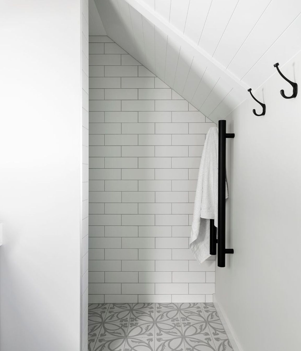 The palette of subtle tones and textural elements continues in this ensuite bathroom.