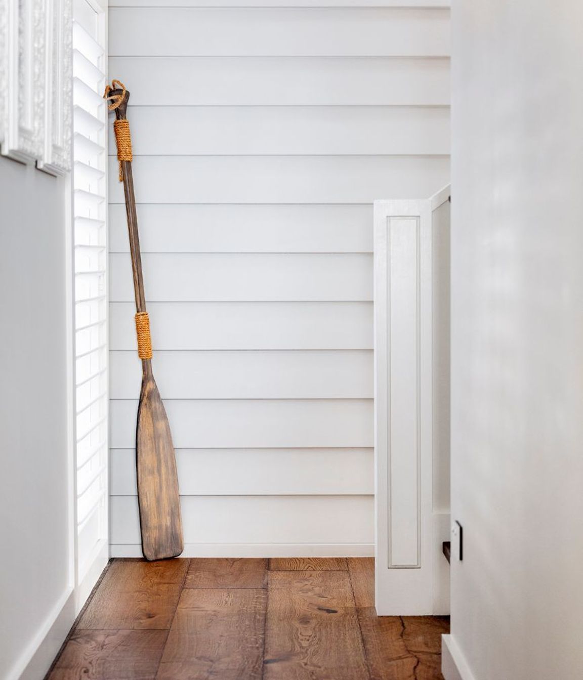 Programmatically, the house is two connected pavilions, accessed by weatherboard-clad staircases.