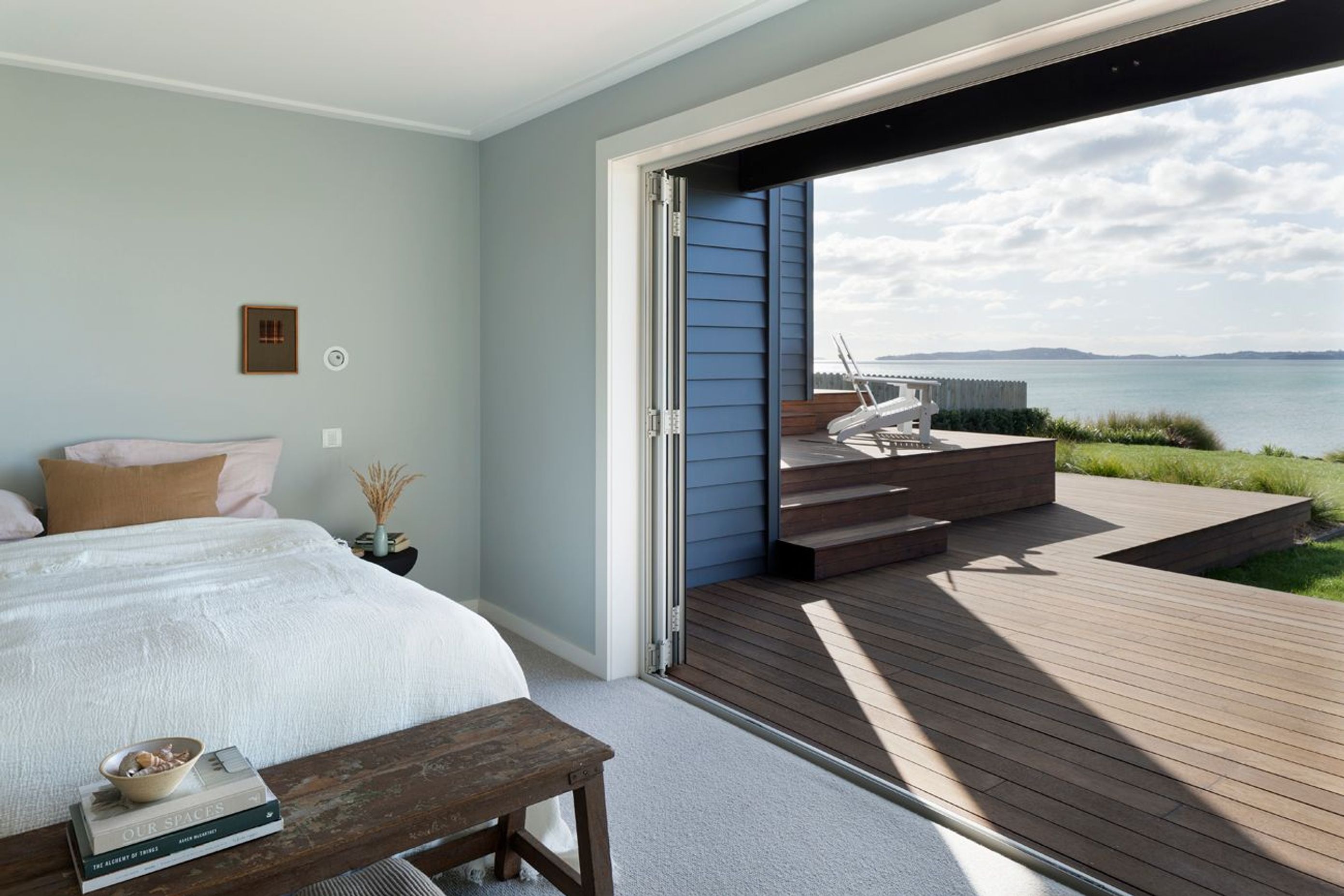 A bank of bifold doors provides seamless egress to the outdoors from this bedroom suite. An elevated viewing platform is the ideal spot to watch the world go by.