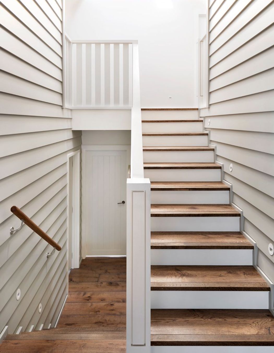 Skylights above the stairwells ensure ample natural light floods into every level of the home as well as acting as passive cooling elements.
