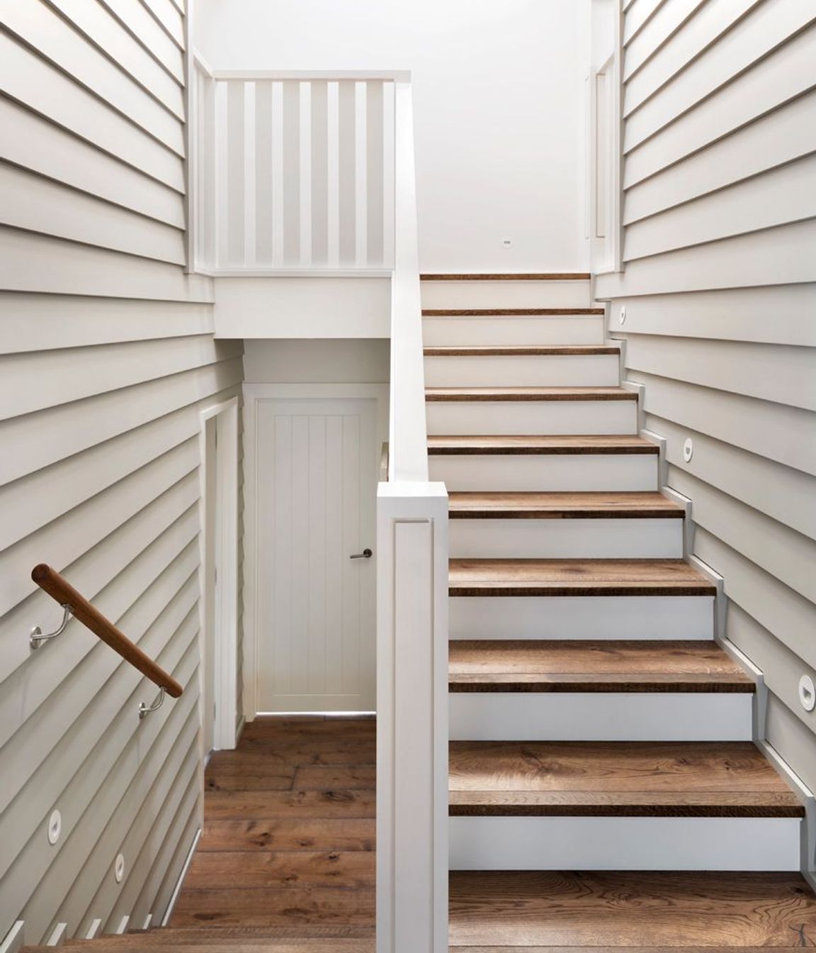 Skylights above the stairwells ensure ample natural light floods into every level of the home as well as acting as passive cooling elements.