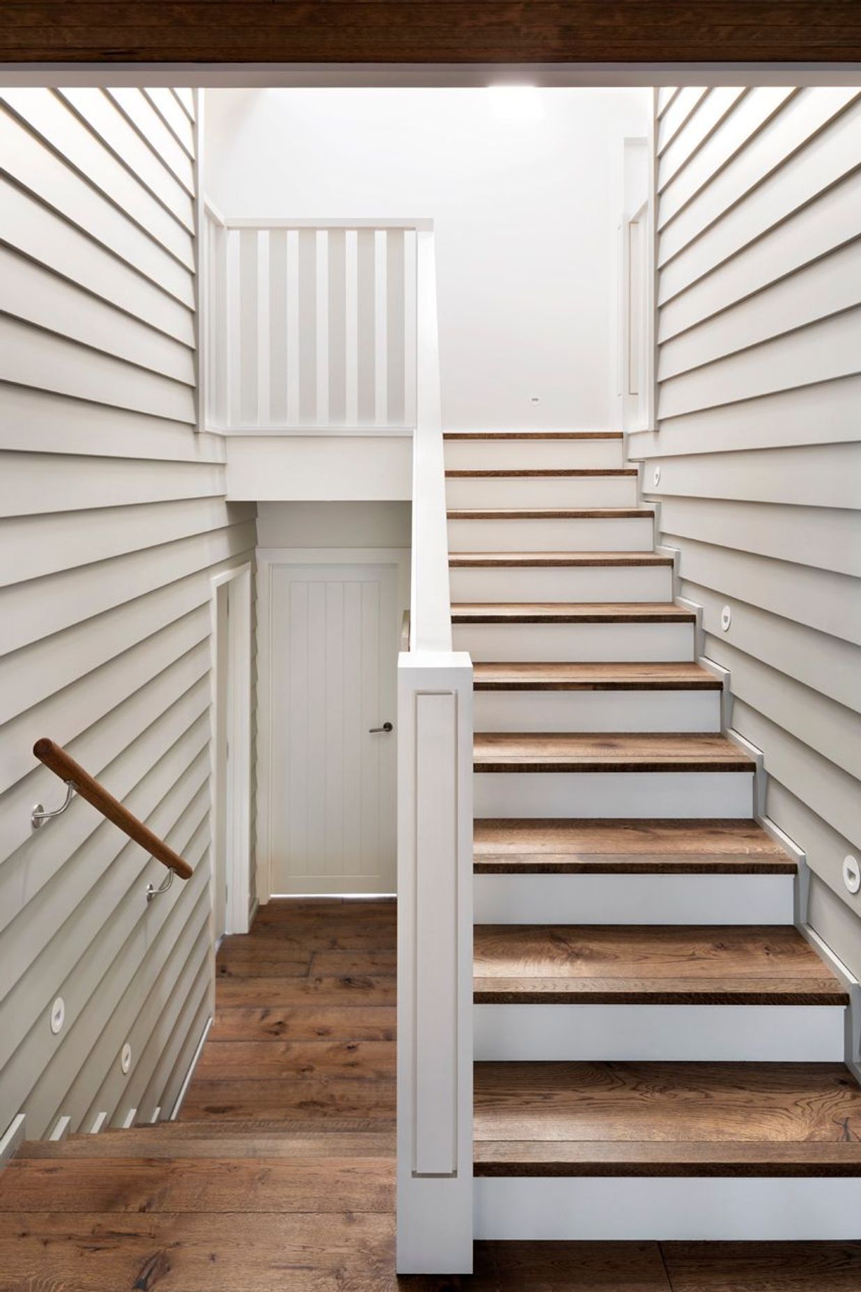 Skylights above the stairwells ensure ample natural light floods into every level of the home as well as acting as passive cooling elements.