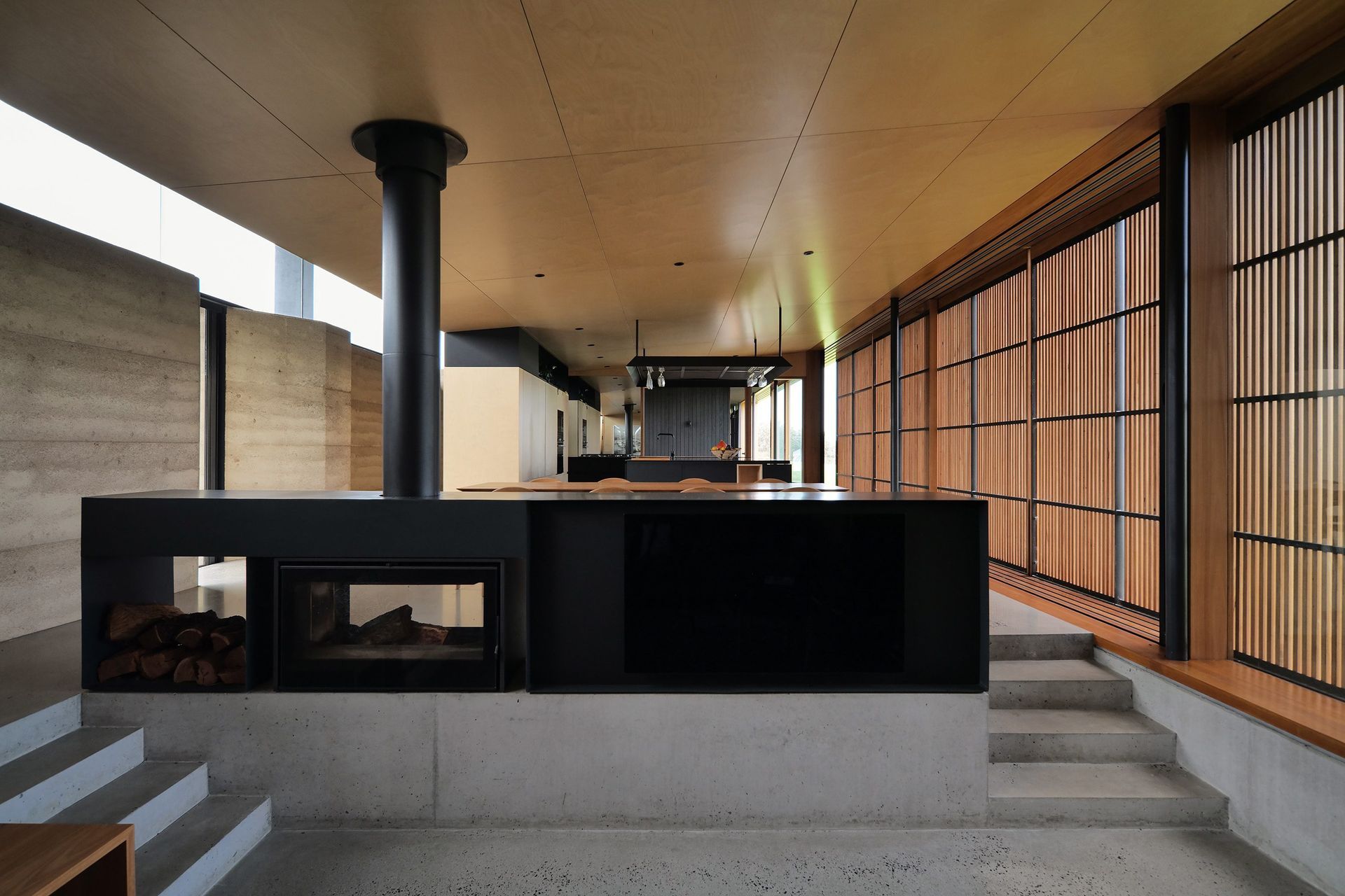 Ignite tranquility and beauty: The thoughtfully crafted Axis i1000 Freestanding Double Sided fireplace in Mystery Bay House enhances the ambiance, offering a serene focal point in this architectural masterpiece