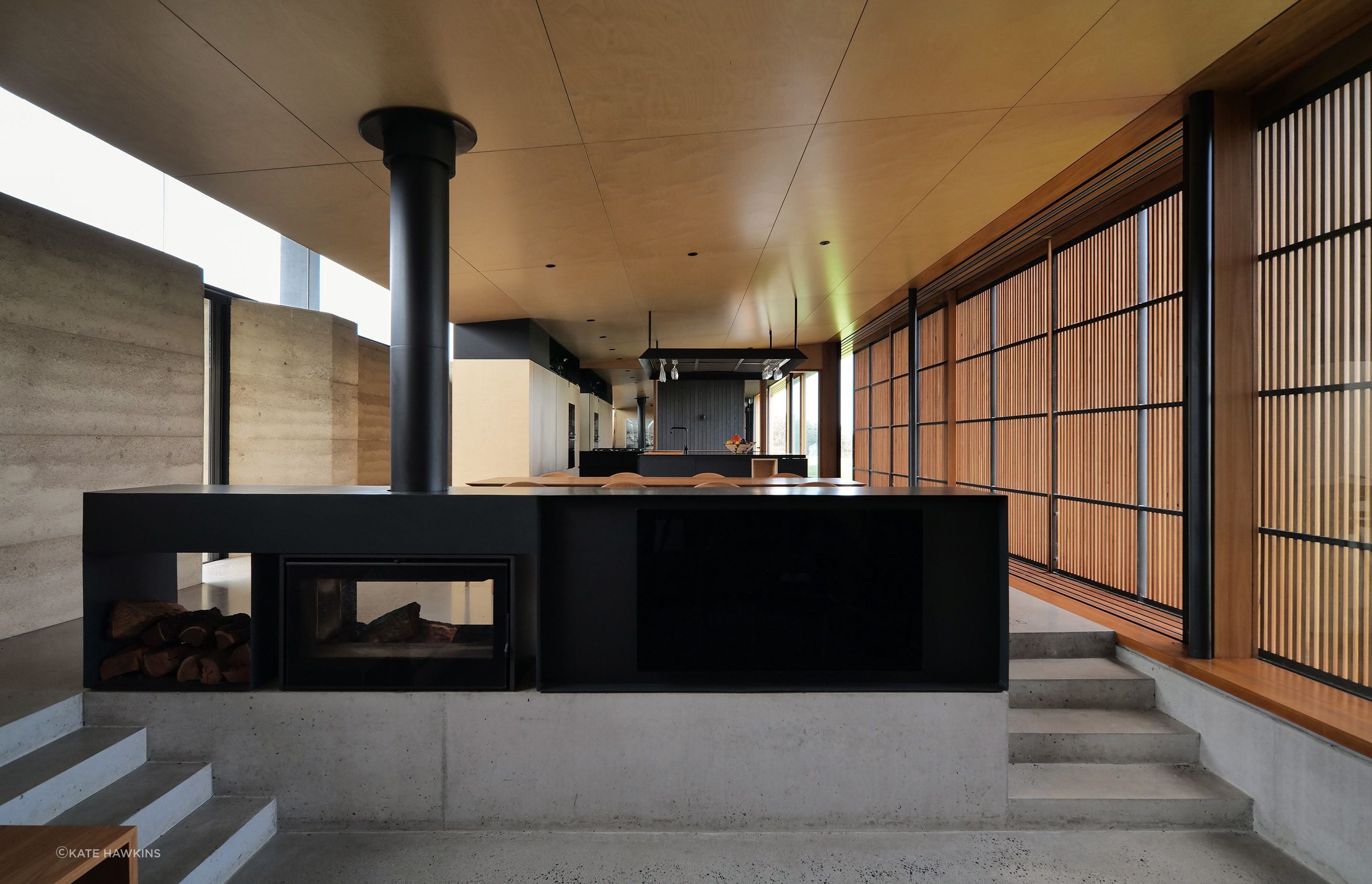Ignite tranquility and beauty: The thoughtfully crafted Axis i1000 Freestanding Double Sided fireplace in Mystery Bay House enhances the ambiance, offering a serene focal point in this architectural masterpiece