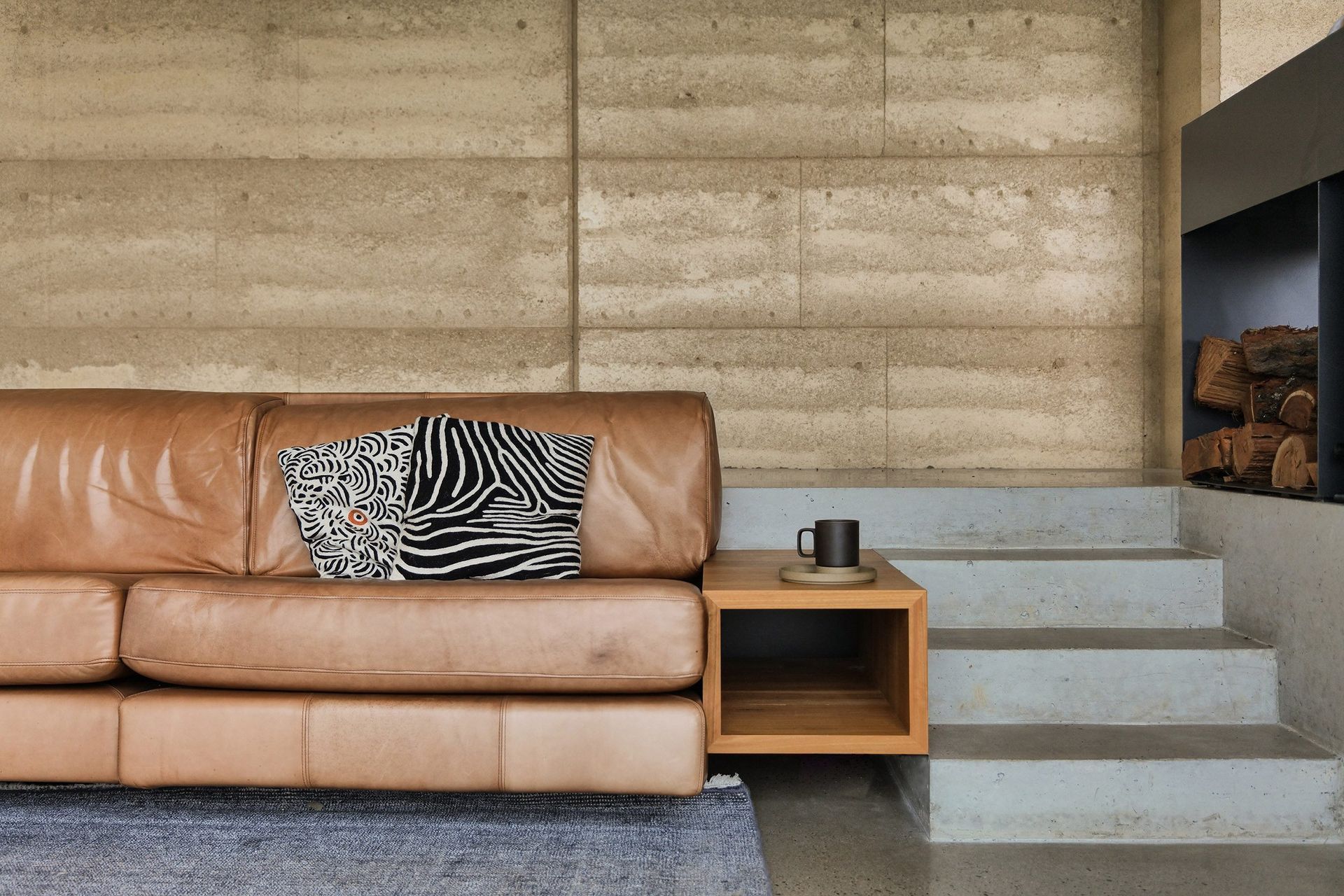 Refined details in the lounge area, perfectly seated next to the luxury Axis i1000 Freestanding Double Sided wood fireplace from Sculpt Fireplace Collection