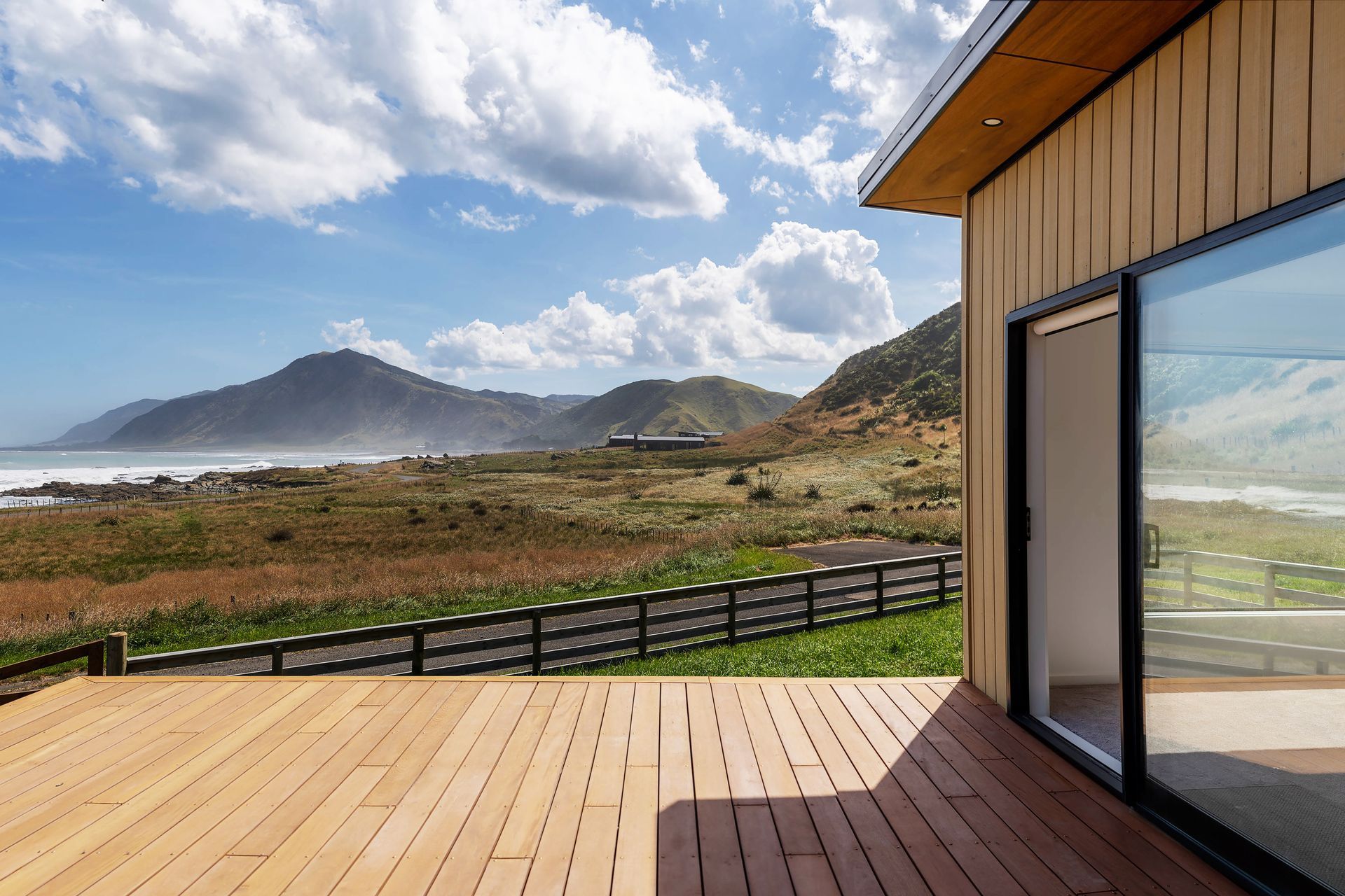 Hardwood decking and Abodo timber cladding frame this spectacular coastal view