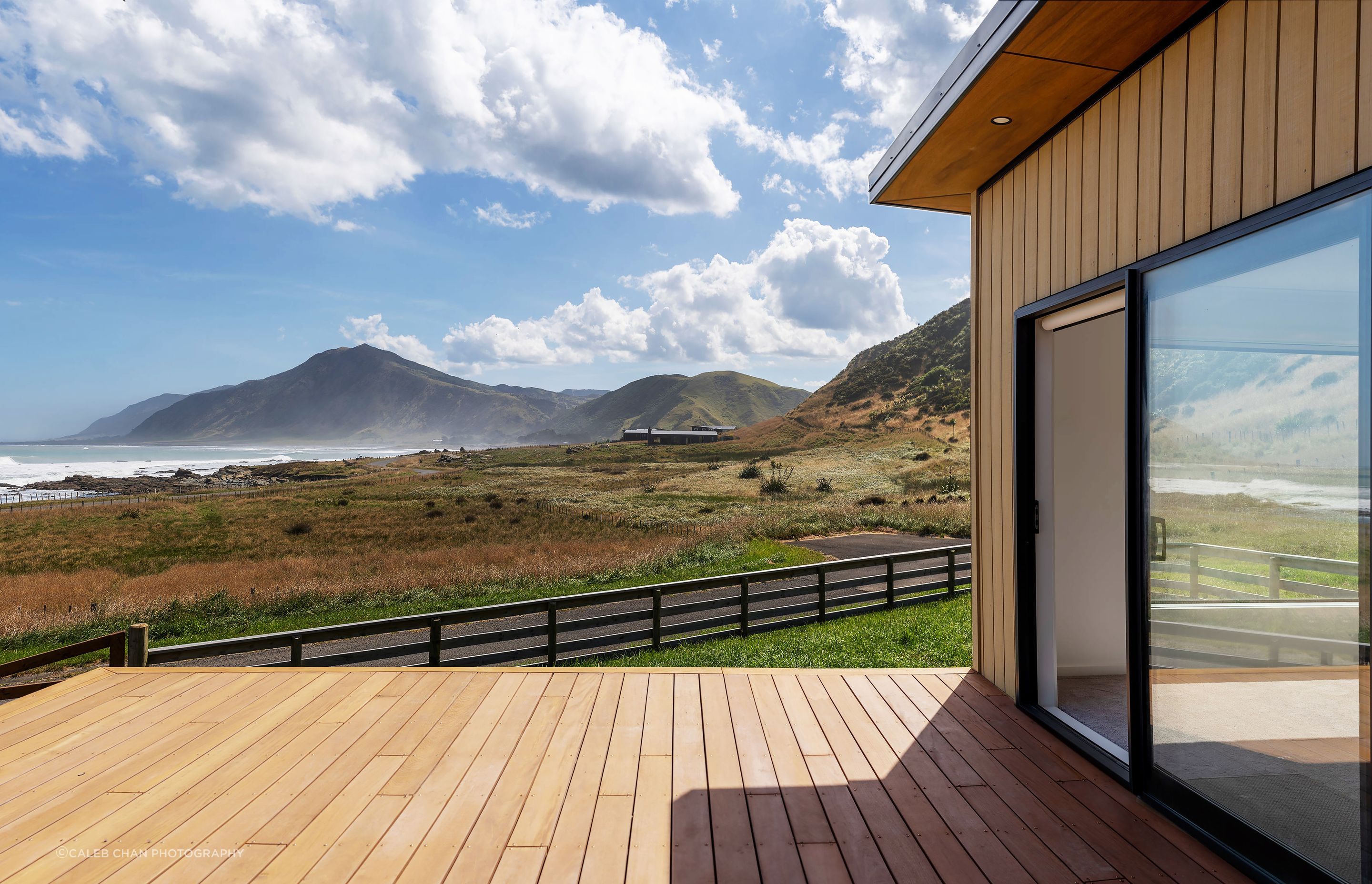 Hardwood decking and Abodo timber cladding frame this spectacular coastal view