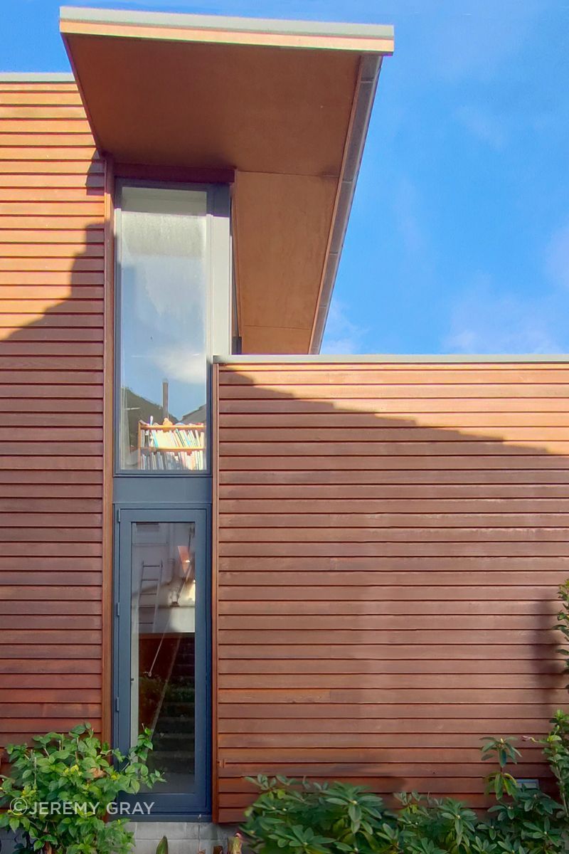 Cantilevered roof calculated to shade summer sun and allow full midday winter sun, as shown here
