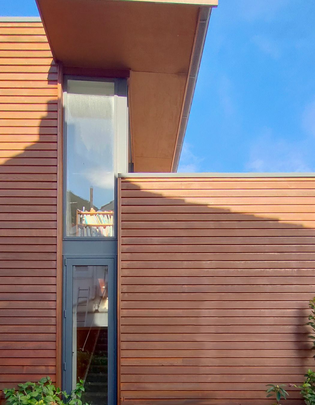 Cantilevered roof calculated to shade summer sun and allow full midday winter sun, as shown here