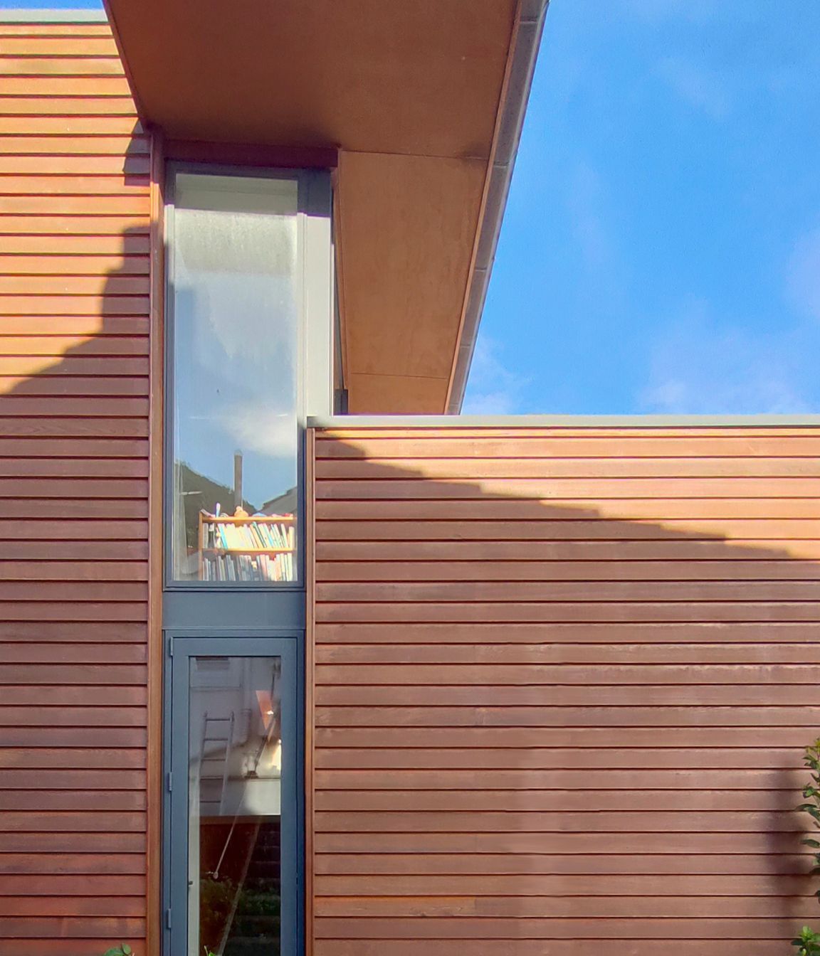 Cantilevered roof calculated to shade summer sun and allow full midday winter sun, as shown here