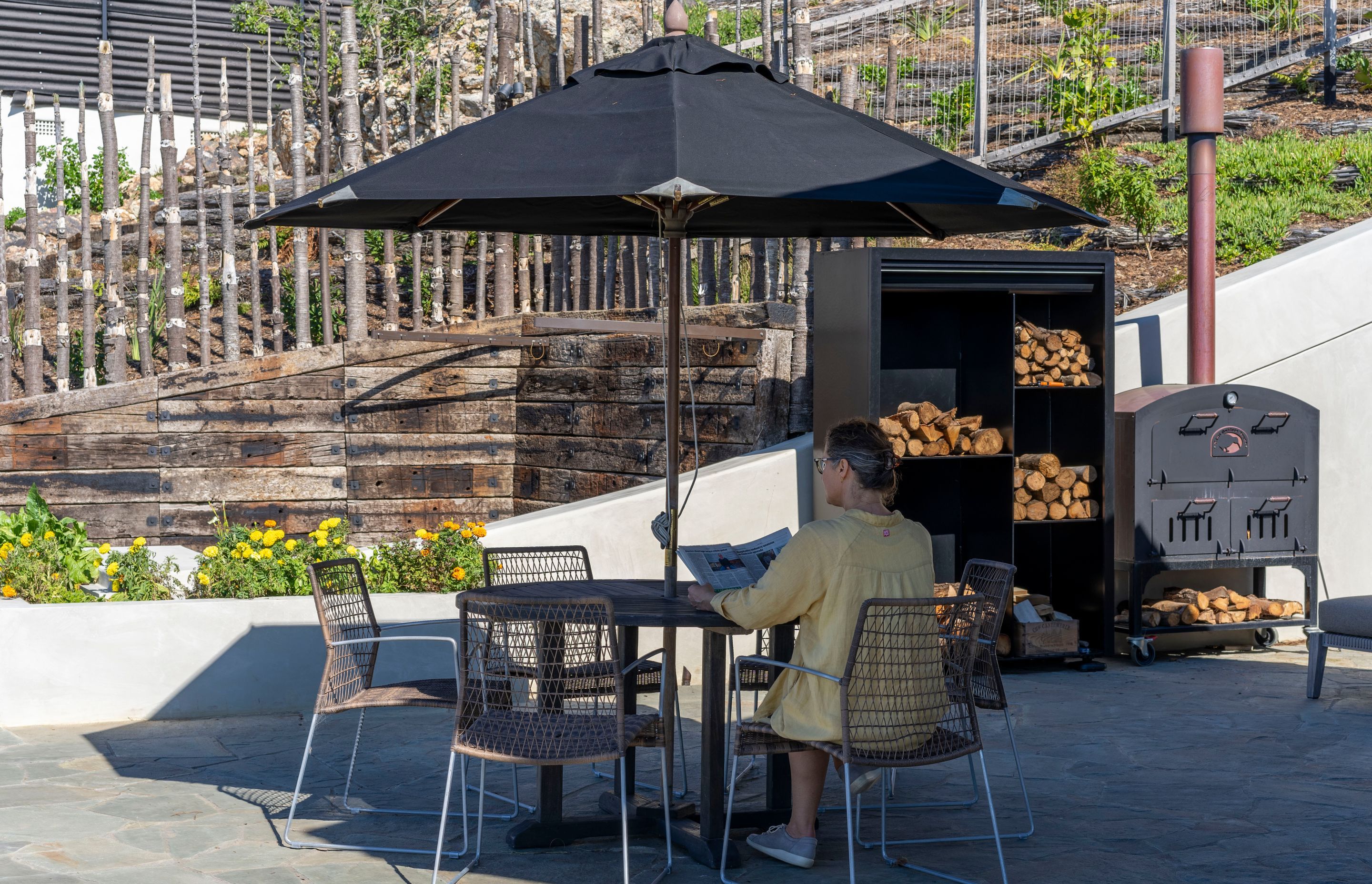 The concrete retaining wall creates a sheltered, multifunctional outdoor space.