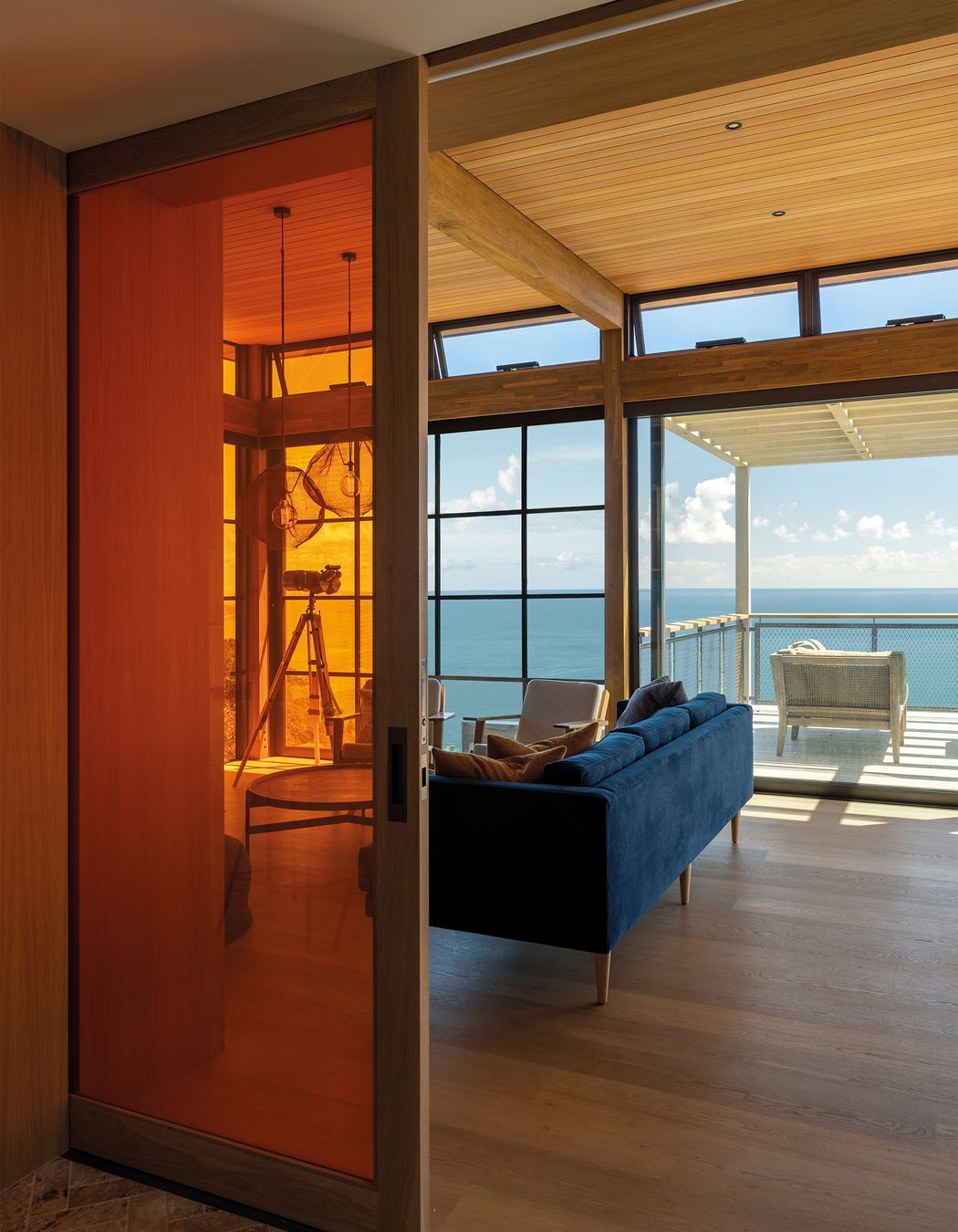 A vibrant tangerine door can be used to separate the living area.