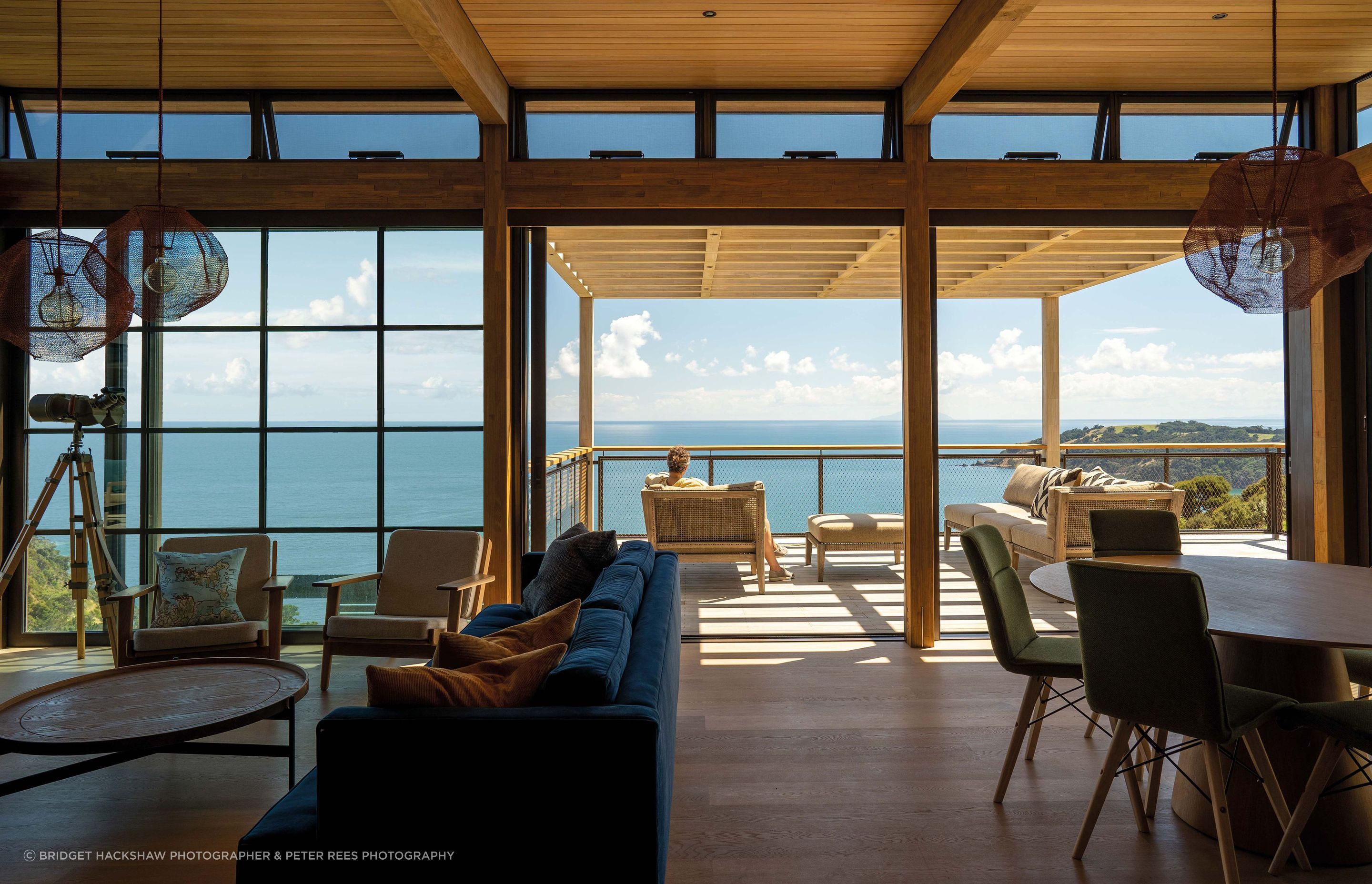 An outdoor living area extends from the interior open-plan living/dining space.